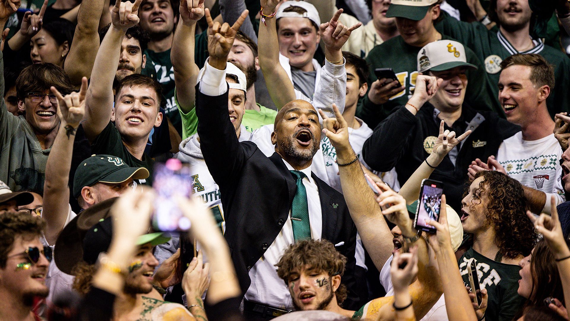 USF head coach Amir Abdur-Rahim celebrating with fans