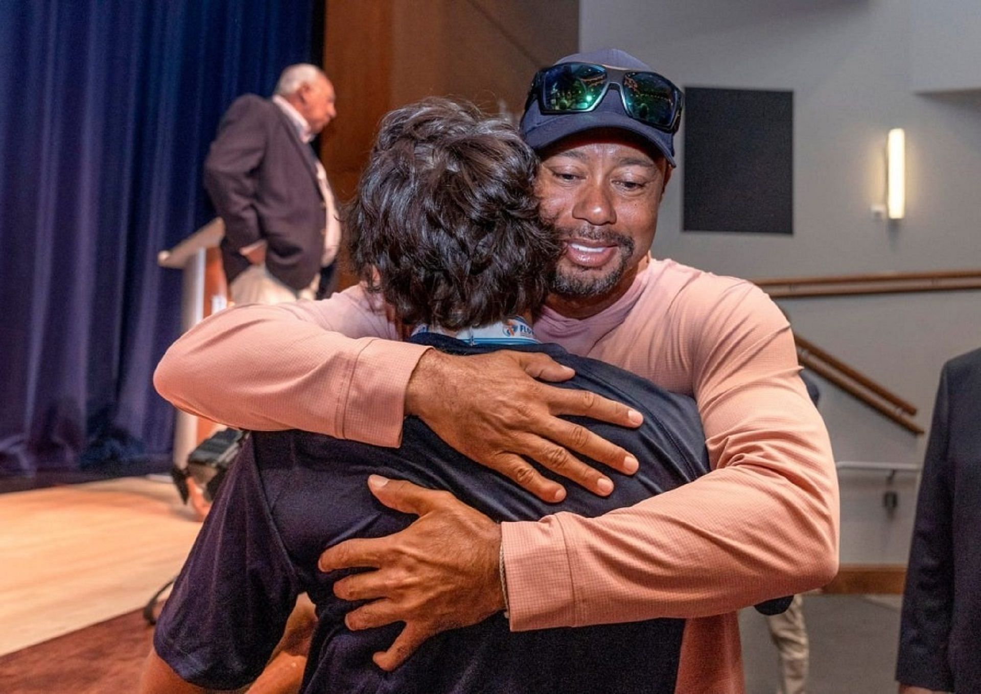 Tiger Woods embraces Charlie Woods at the state golf championship ring ceremony