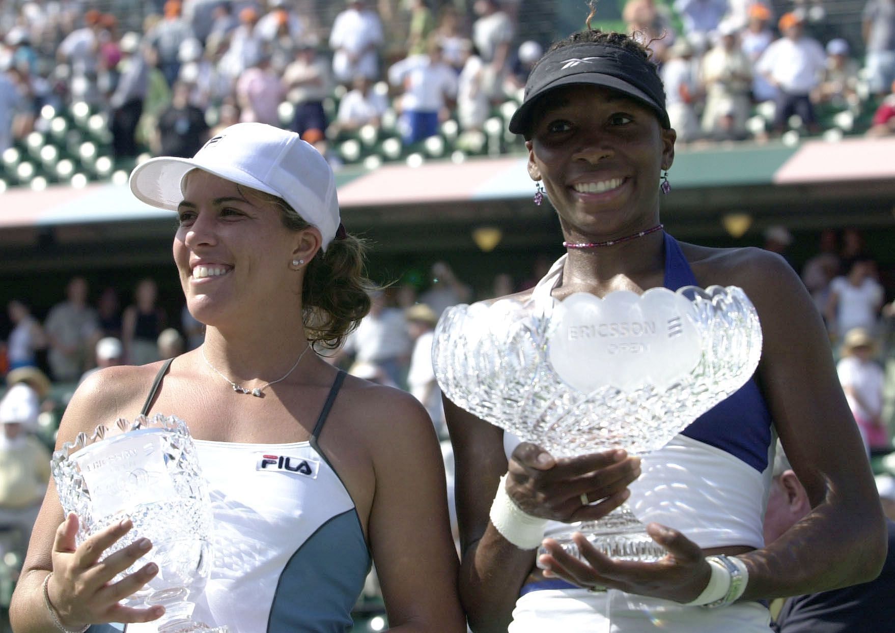 Venus Williams (R) holds the Miami Open 2001 women&#039;s singles trophy beside runner-up Jennifer Capriati.