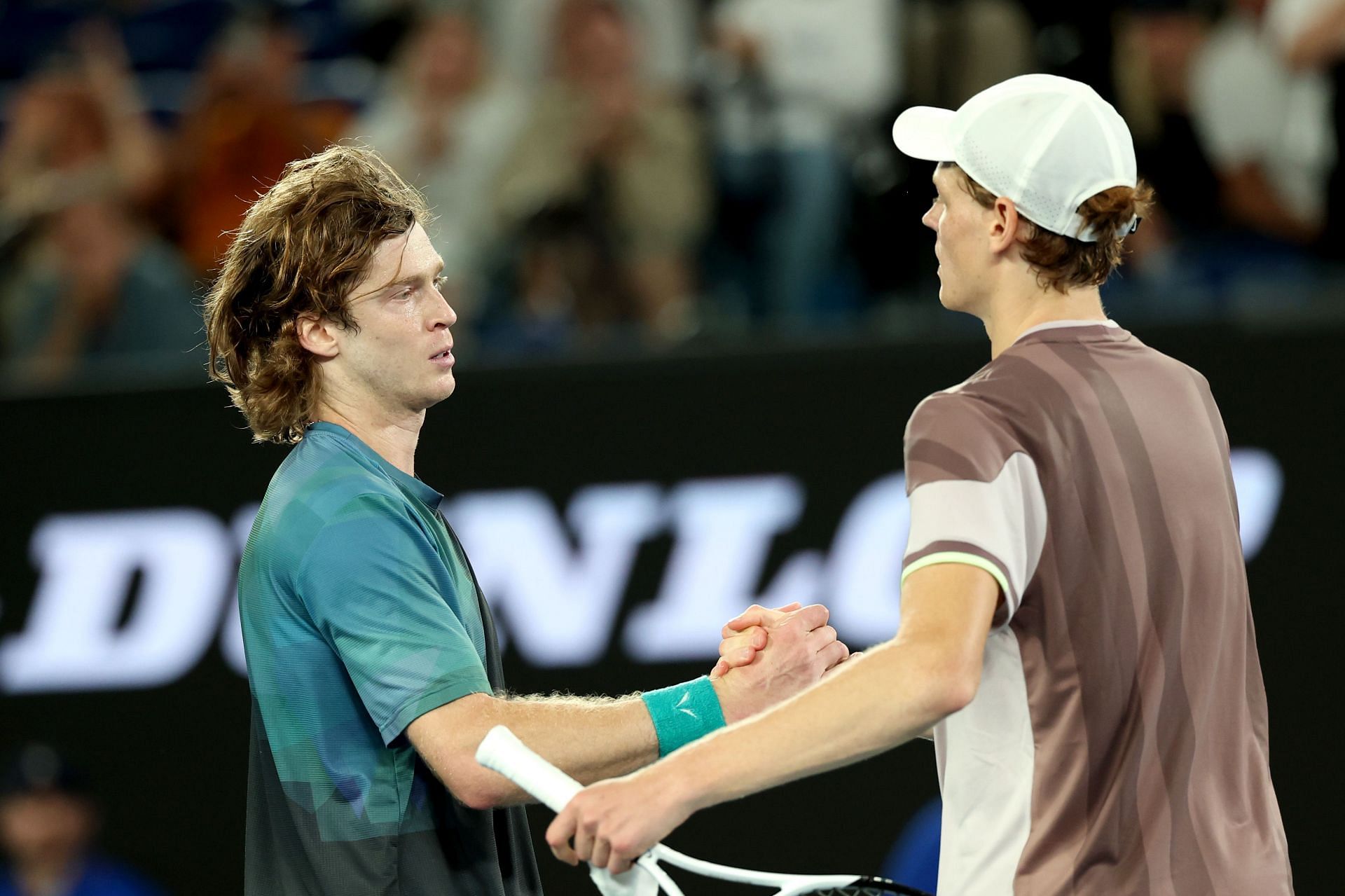 Andrey Rublev and Jannik Sinner (R) shake hands