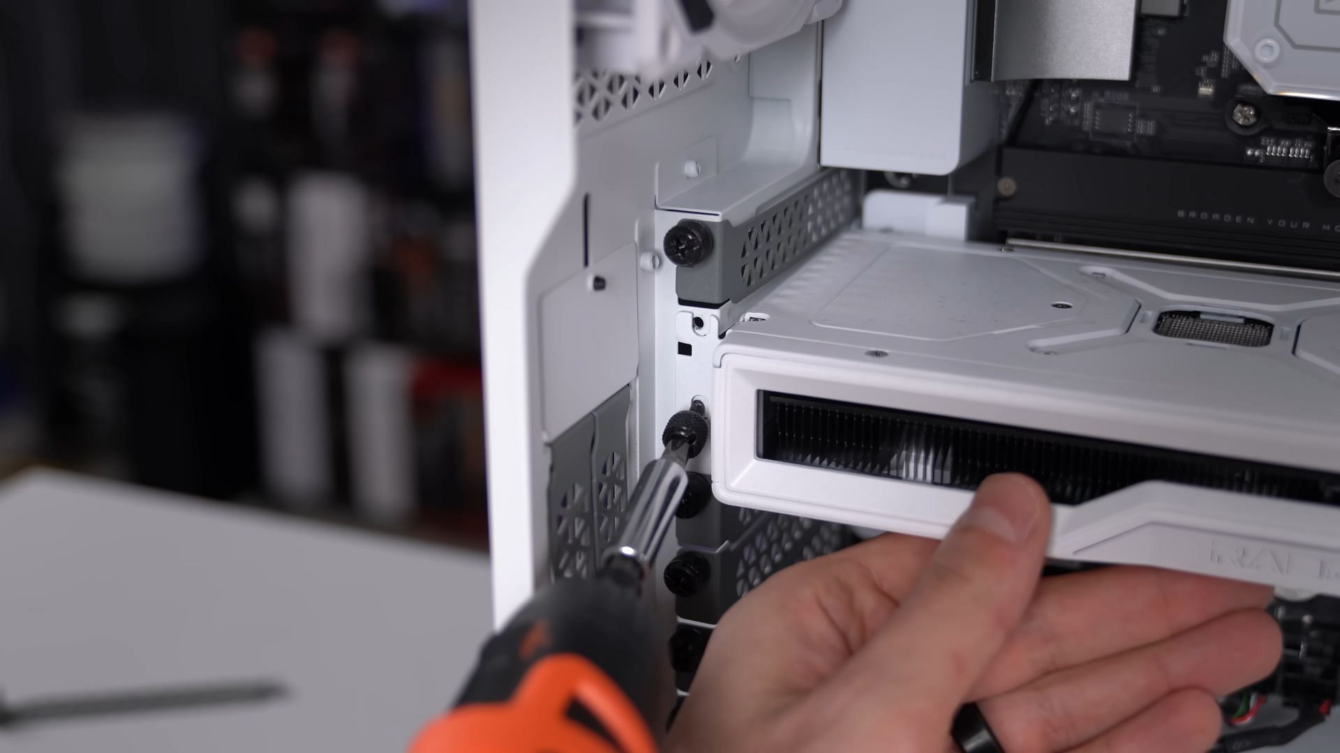 The GPU is installed and getting screwed in (Image via TechSource/YouTube)