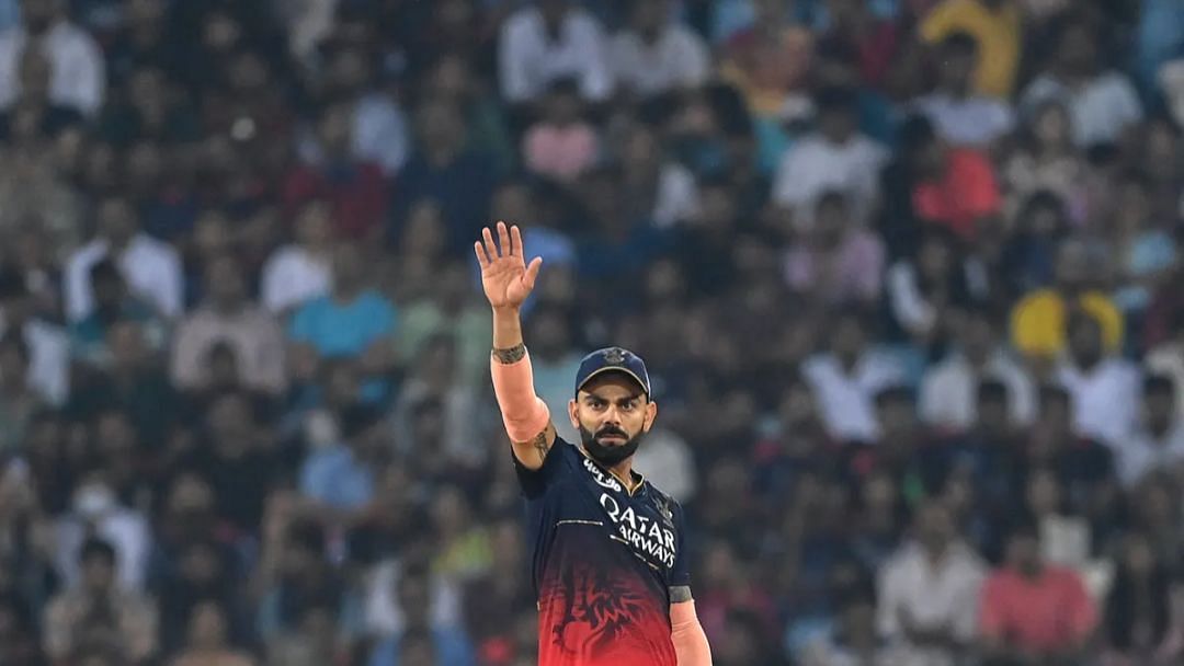 Virat Kohli waving his hand while fielding