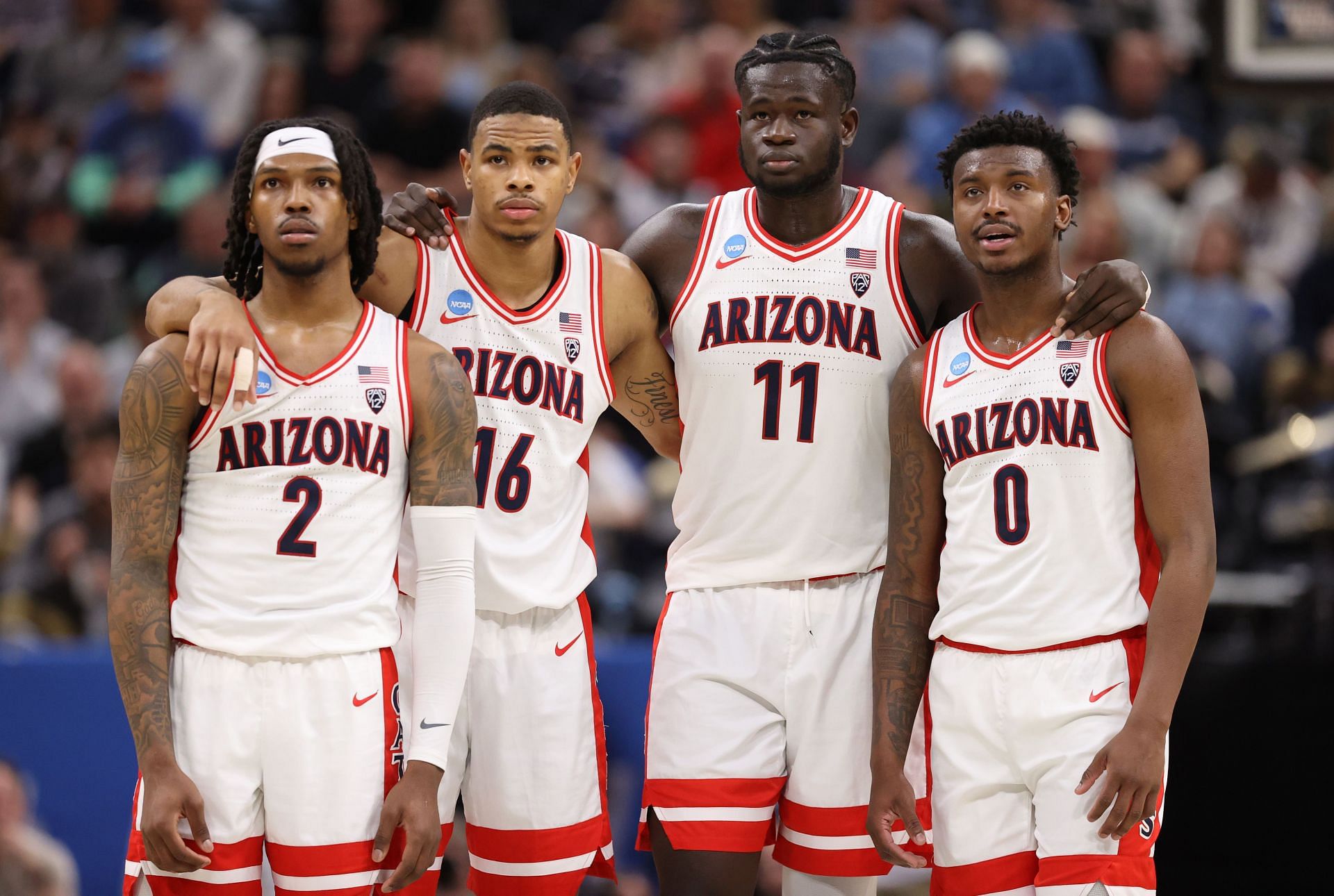 Caleb Love #2, Keshad Johnson #16, Oumar Ballo #11, and Jaden Bradley #0 of the Arizona Wildcats.