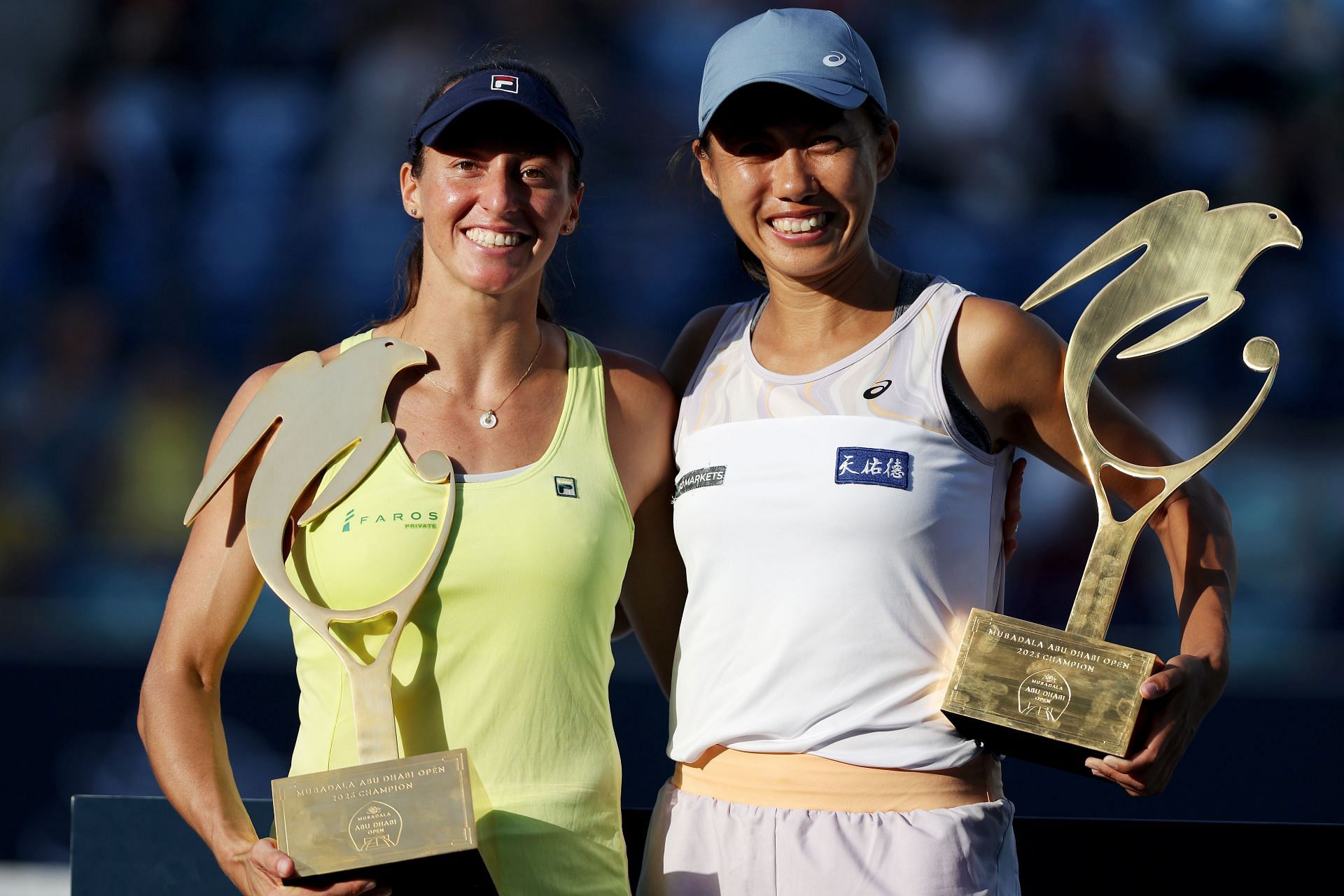 Shuai Zhang(R) and Luisa Stefani pose with their Abu Dhabi Open trophy