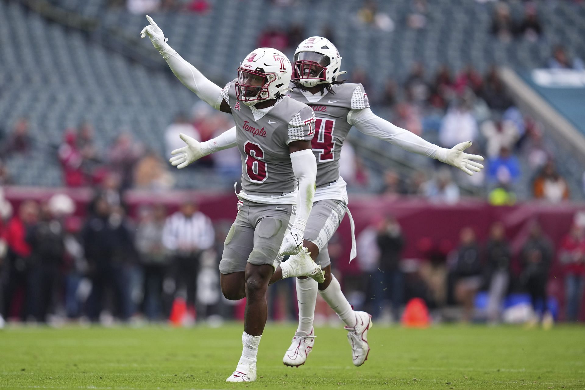 Jordan Magee #6 and Diwun Black #34 of the Temple Owls celebrate after a sack by Magee against the Navy Midshipmen