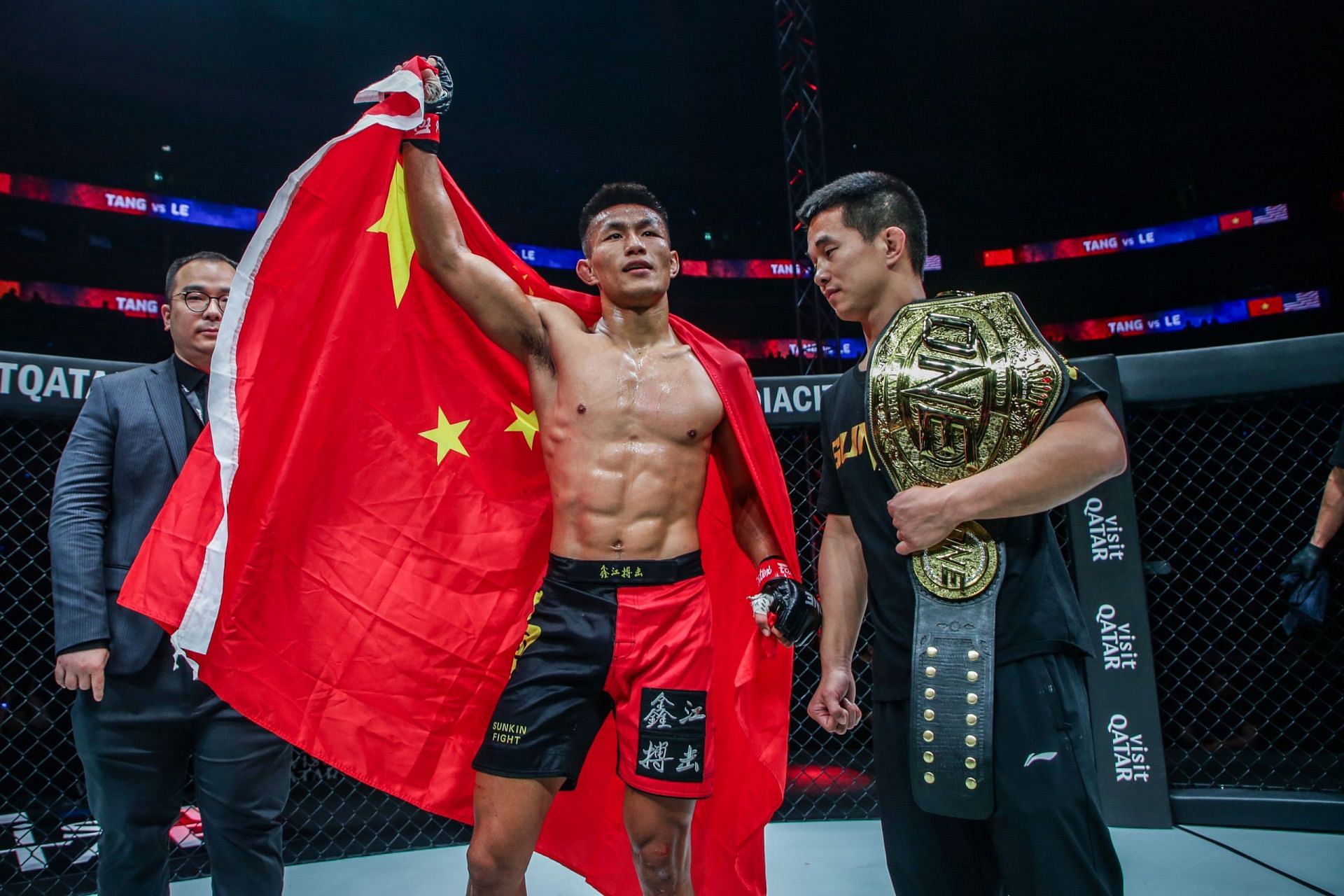 Tang Kai celebrates after unifying the ONE Championship featherweight MMA titles in Doha.