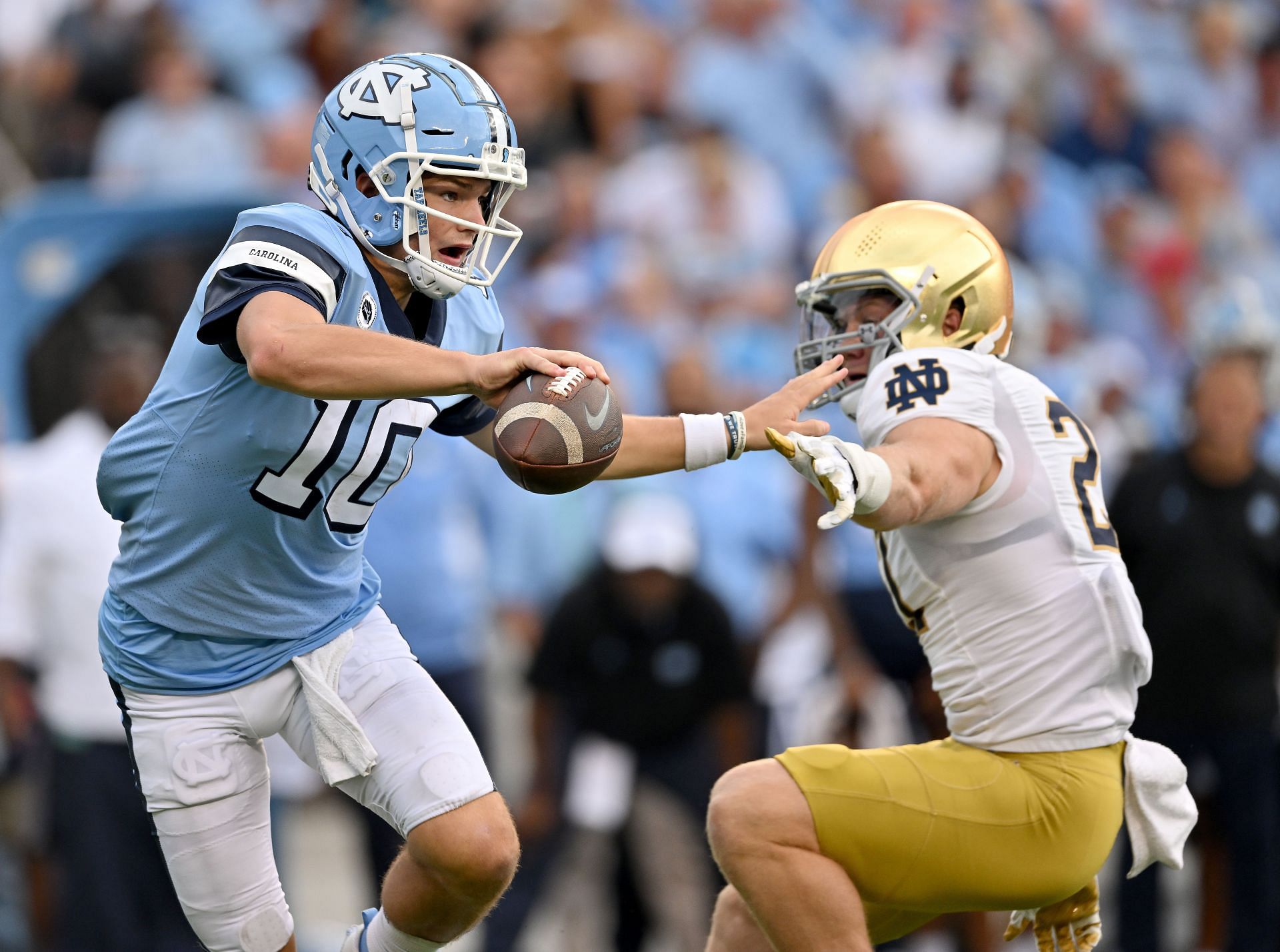 J.D. Bertrand #27 of the Notre Dame Fighting Irish pressures Drake Maye #10 of the North Carolina Tar Heels