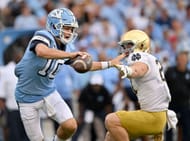 J.D. Bertrand #27 of the Notre Dame Fighting Irish pressures Drake Maye #10 of the North Carolina Tar Heels