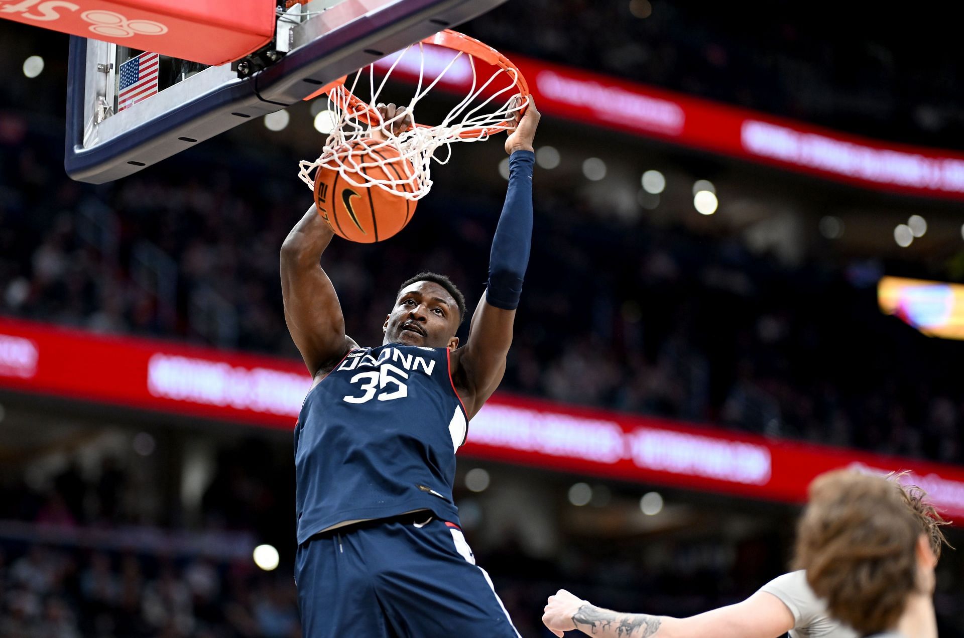 Samson Johnson of the Connecticut Huskies dunks the ball.