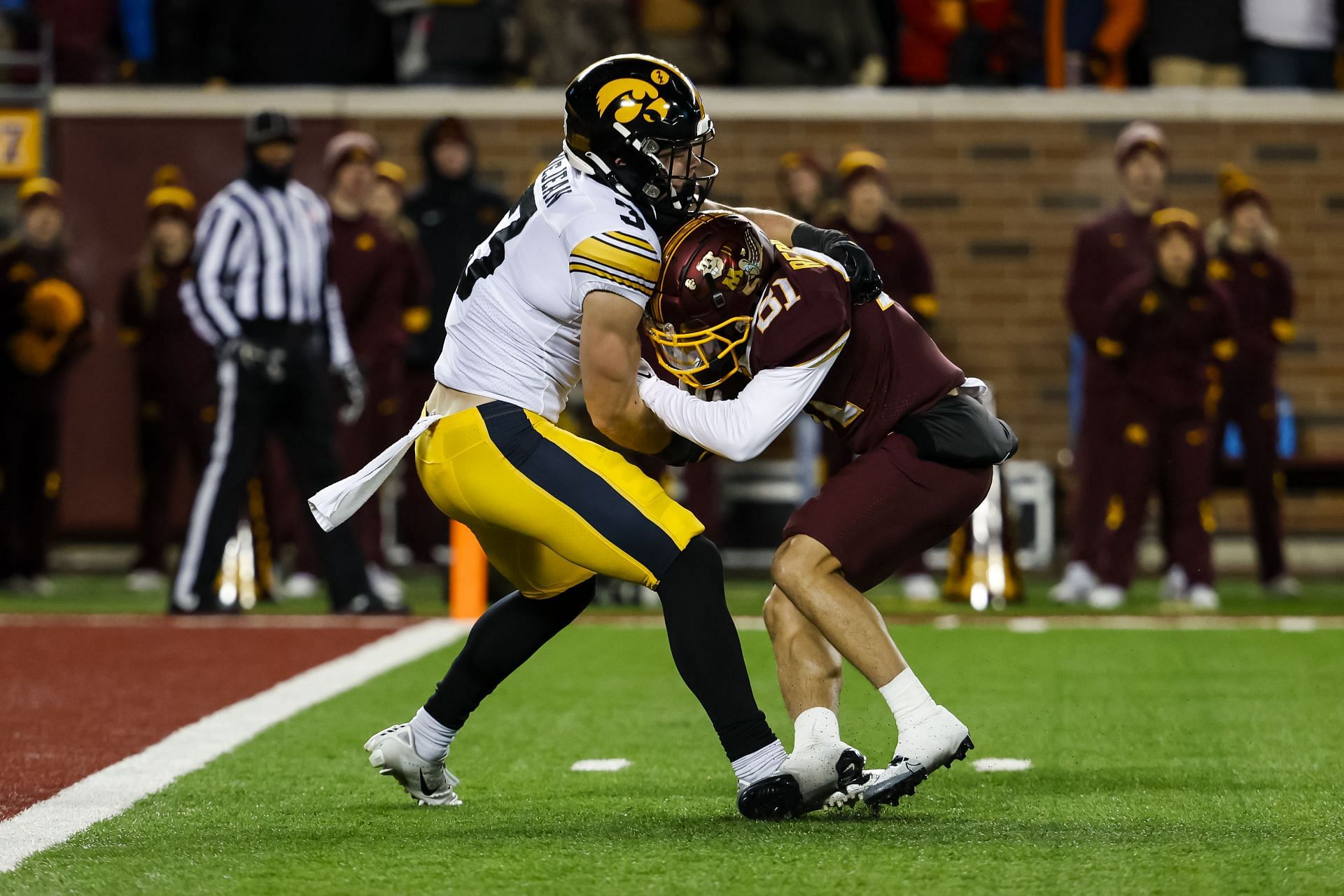 Cooper DeJean #3 of the Iowa Hawkeyes tackles Quentin Redding #81 of the Minnesota Golden Gophers
