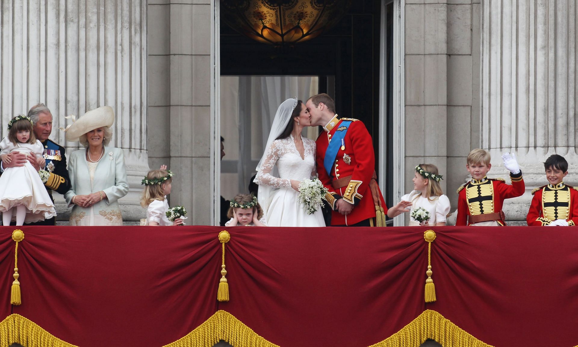 Royal Highnesses Prince William, Duke of Cambridge, and Catherine, Duchess of Cambridge kiss on the balcony at Buckingham Palace (Source: Getty)