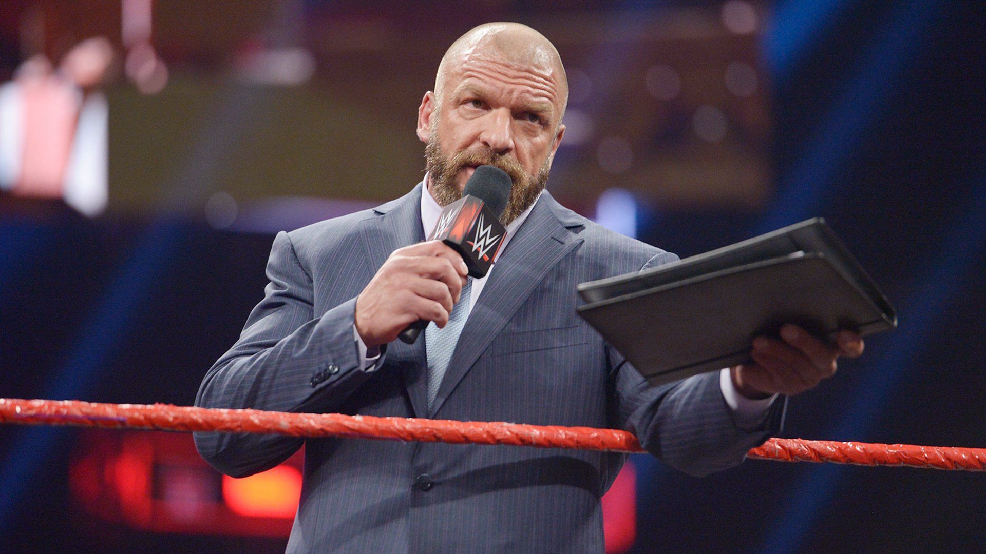 WWE Chief Content Officer Triple H speaks on RAW with a contract in-hand