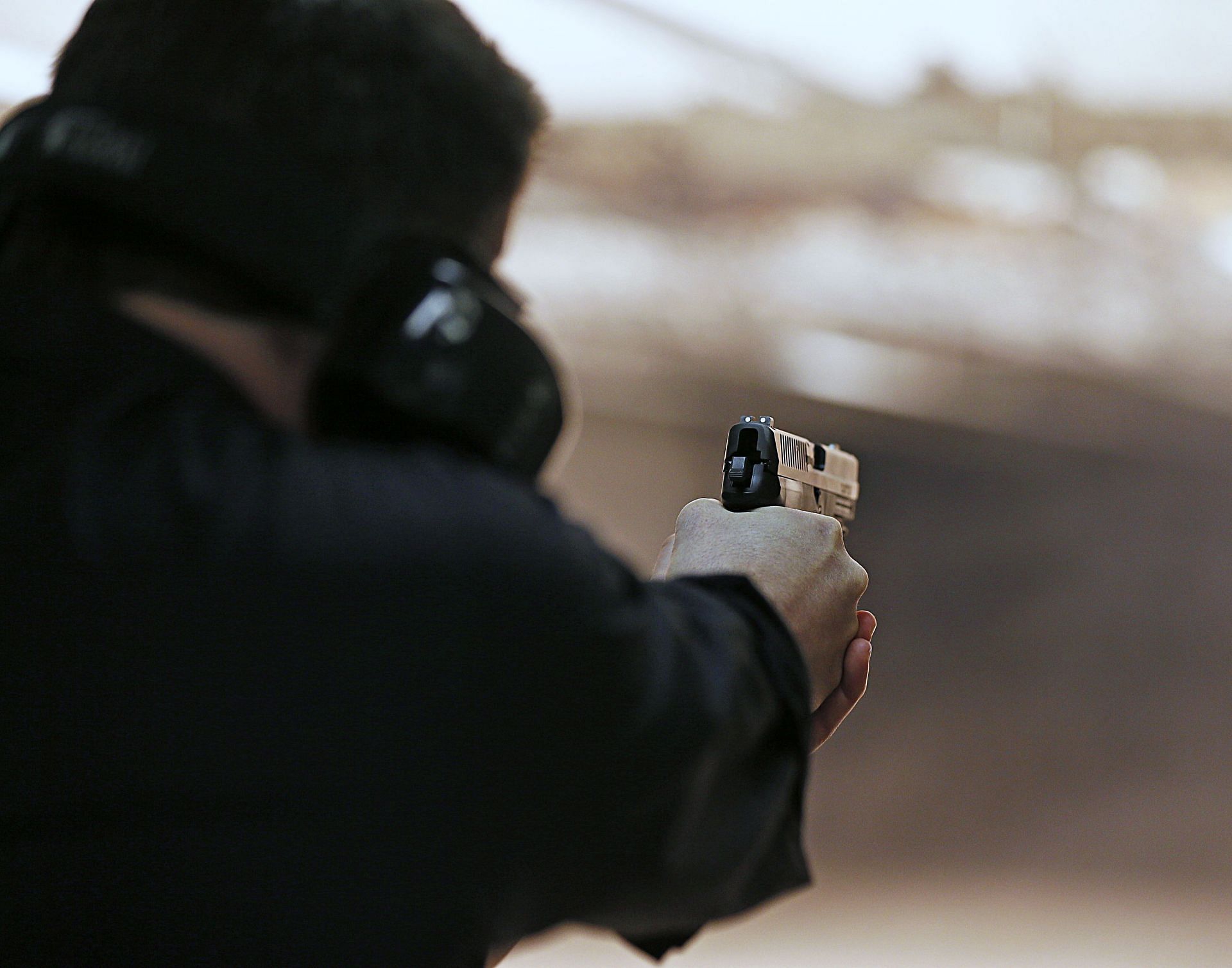 Firearms Enthusiasts Practice Shooting At Gun Range