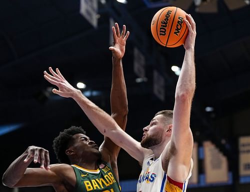 Hunter Dickinson of the Kansas Jayhawks shoots against Yves Missi of the Baylor Bears.