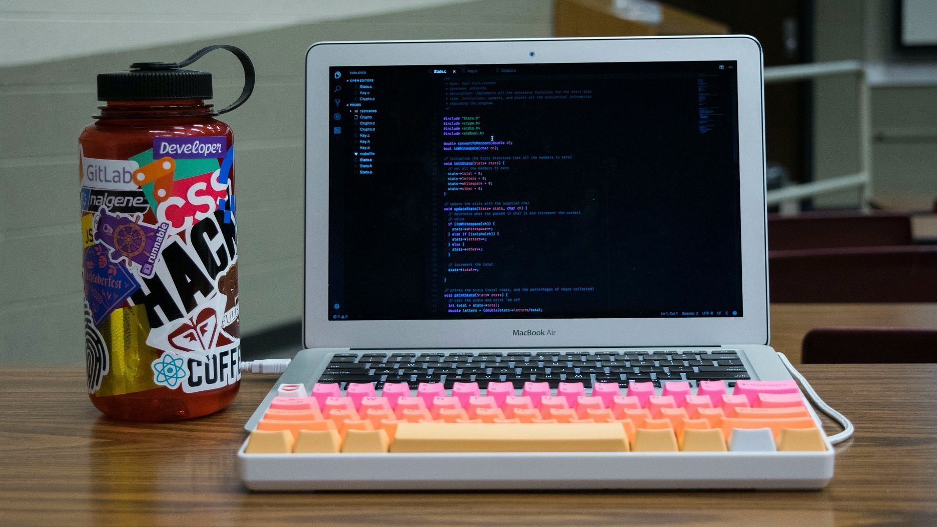 Picture of a MacBook with a colorful external keyboard