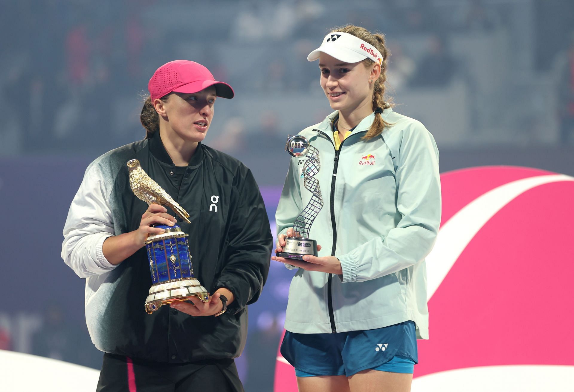 Iga Swiatek (L) and Elena Rybakina (R) during the trophy presentation ceremony at the 2024 Qatar Open