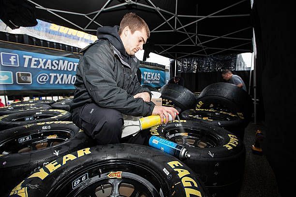 Member of Erik Ford&rsquo;s team working on his Goodyear tires