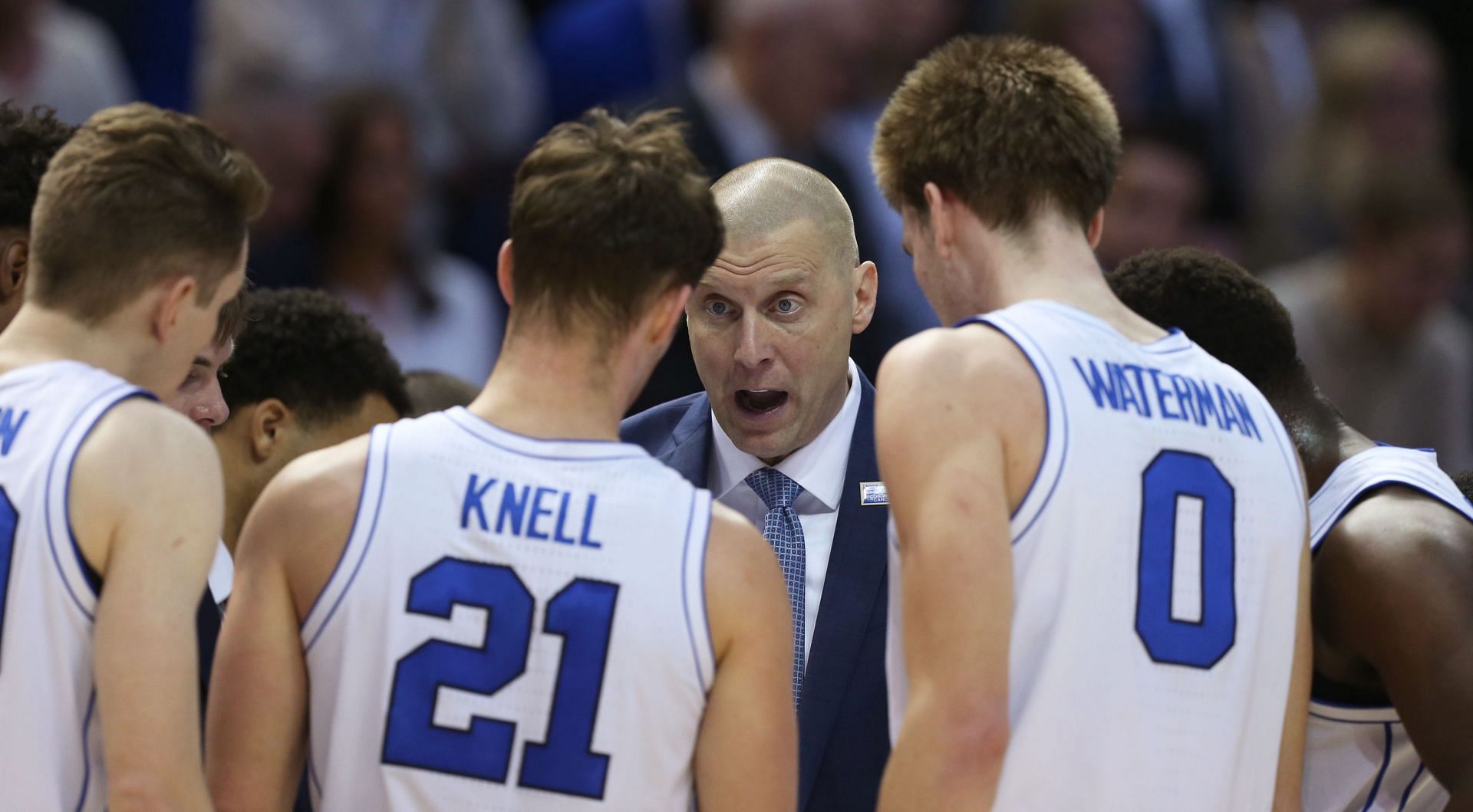 Mark Pope delivers instructions to his team in the huddle.