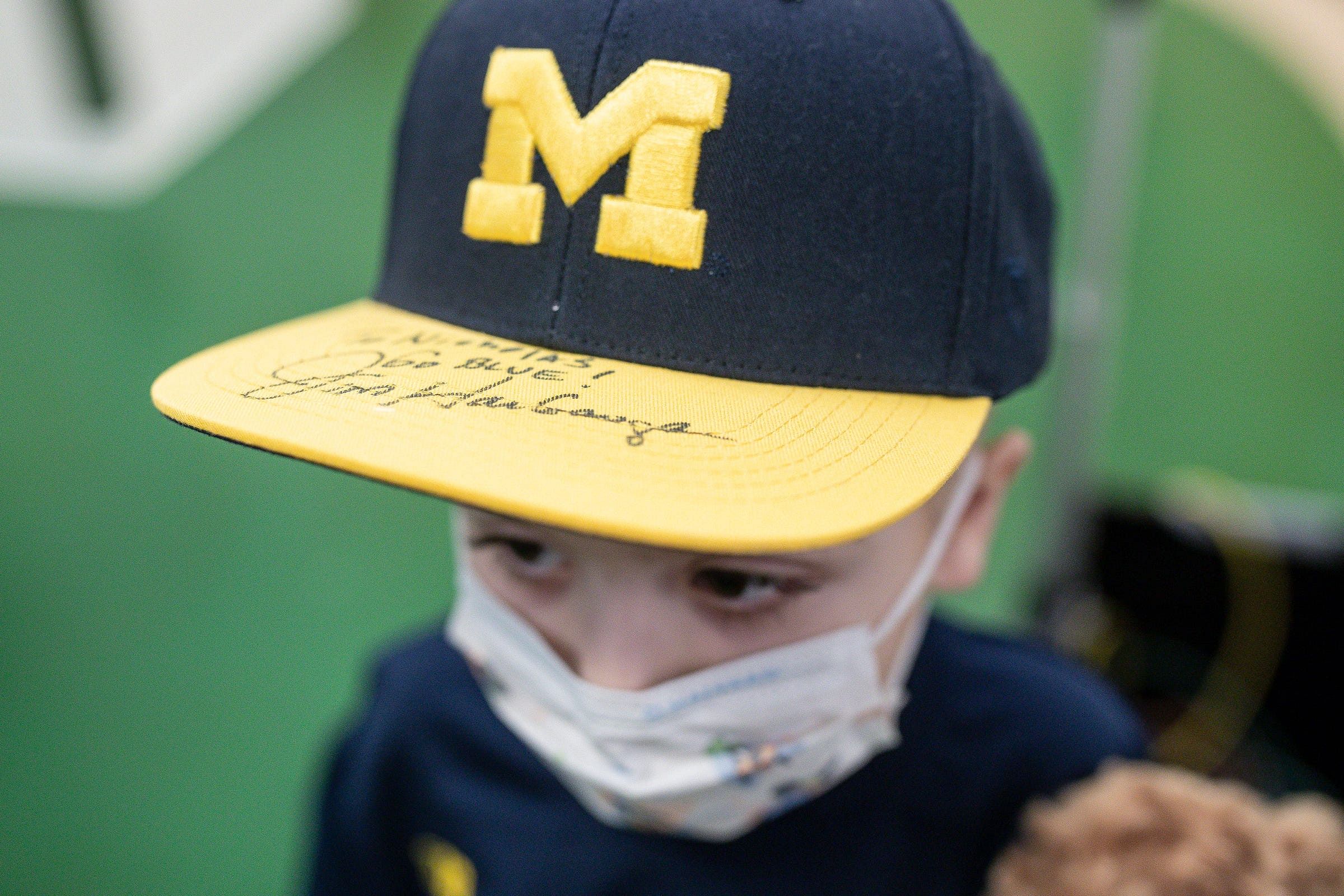 Nicholas Rinehart, 6, shows off his hat signed by Michigan head coach Jim Harbaugh.