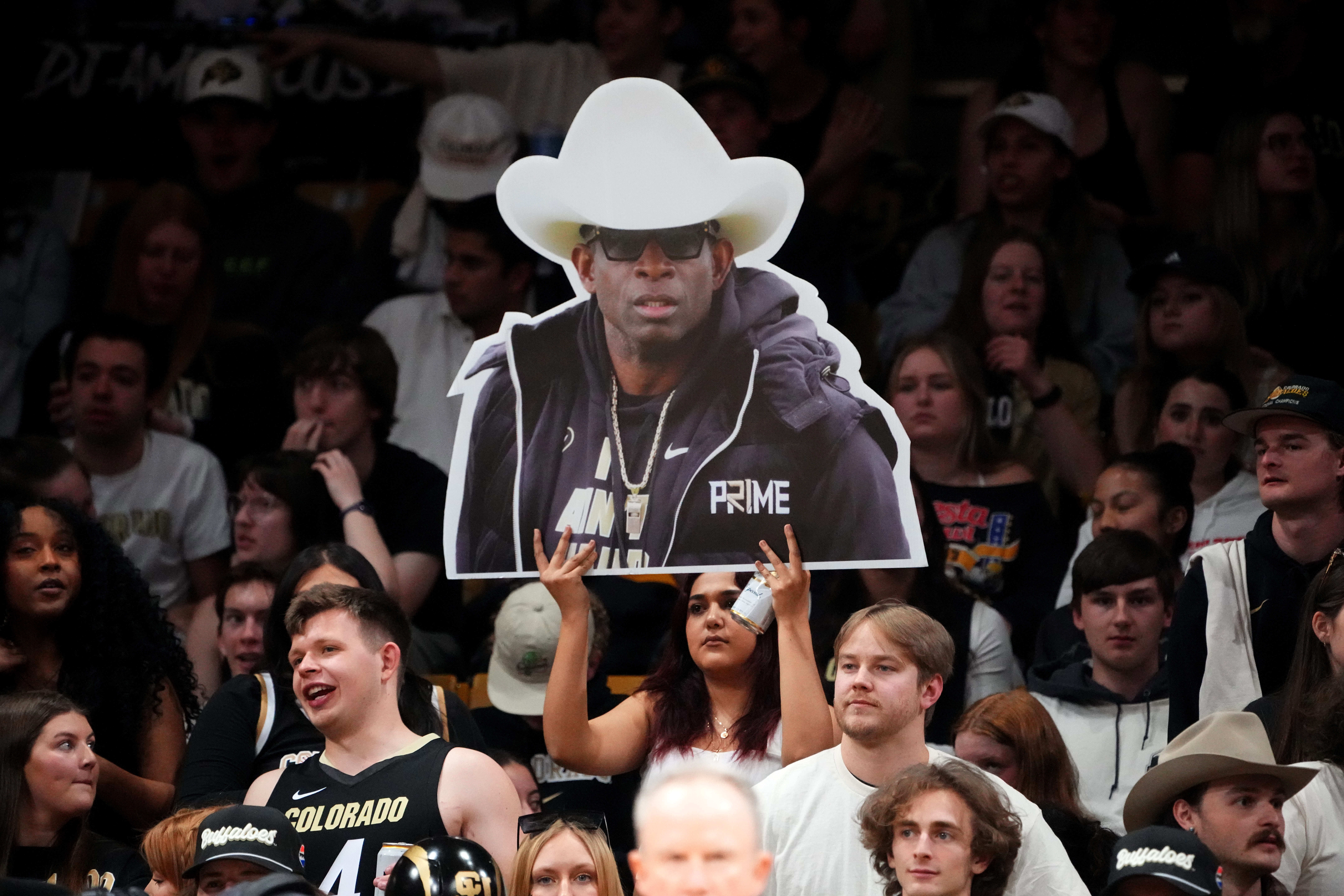 NCAA Basketball: Stanford at Colorado: Mar 3, 2024; Boulder, Colorado, USA; Colorado Buffaloes student fan holds a photo cut out of football head coach Deion Sanders during the second half against the Stanford Cardinal at the CU Events Center. Mandatory Credit: Ron Chenoy, USA TODAY Sports