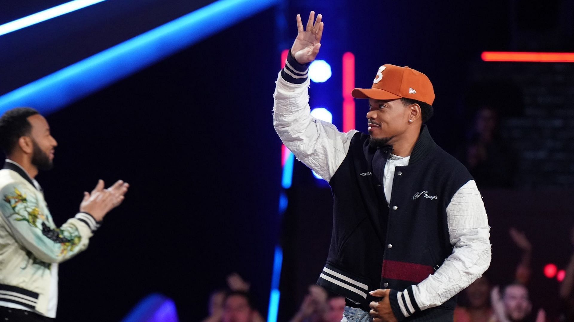 Chance The Rapper standing alongside fellow The Voice coach John Legend during this season