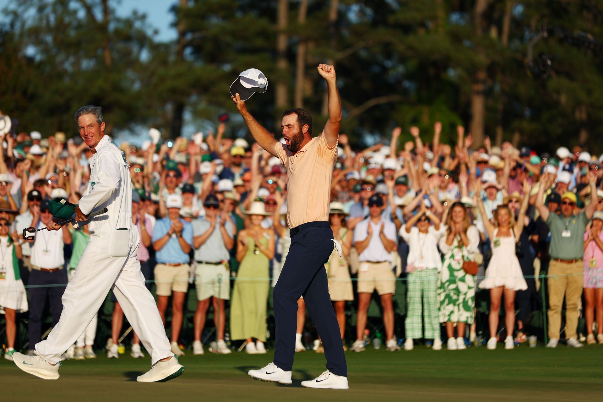 Scottie Scheffler of the United States and caddie Ted Scott celebrate on the 18th green after winning the 2024 Masters Tournament at Augusta National Golf Club (Photo by Maddie Meyer/Getty Images)