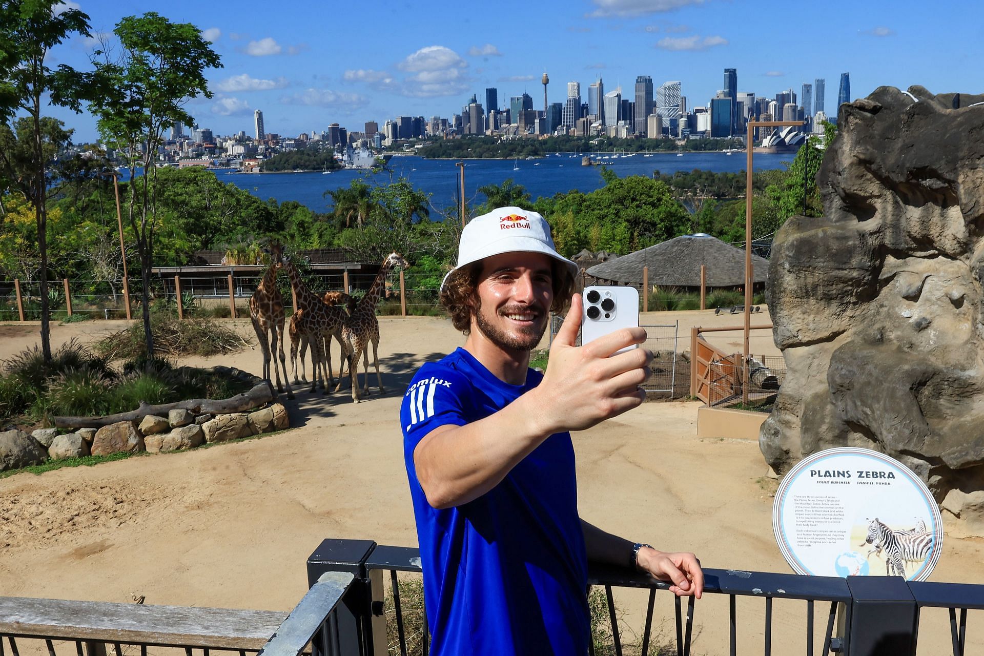 Stefanos Tsitsipas takes a selfie on his smartphone.