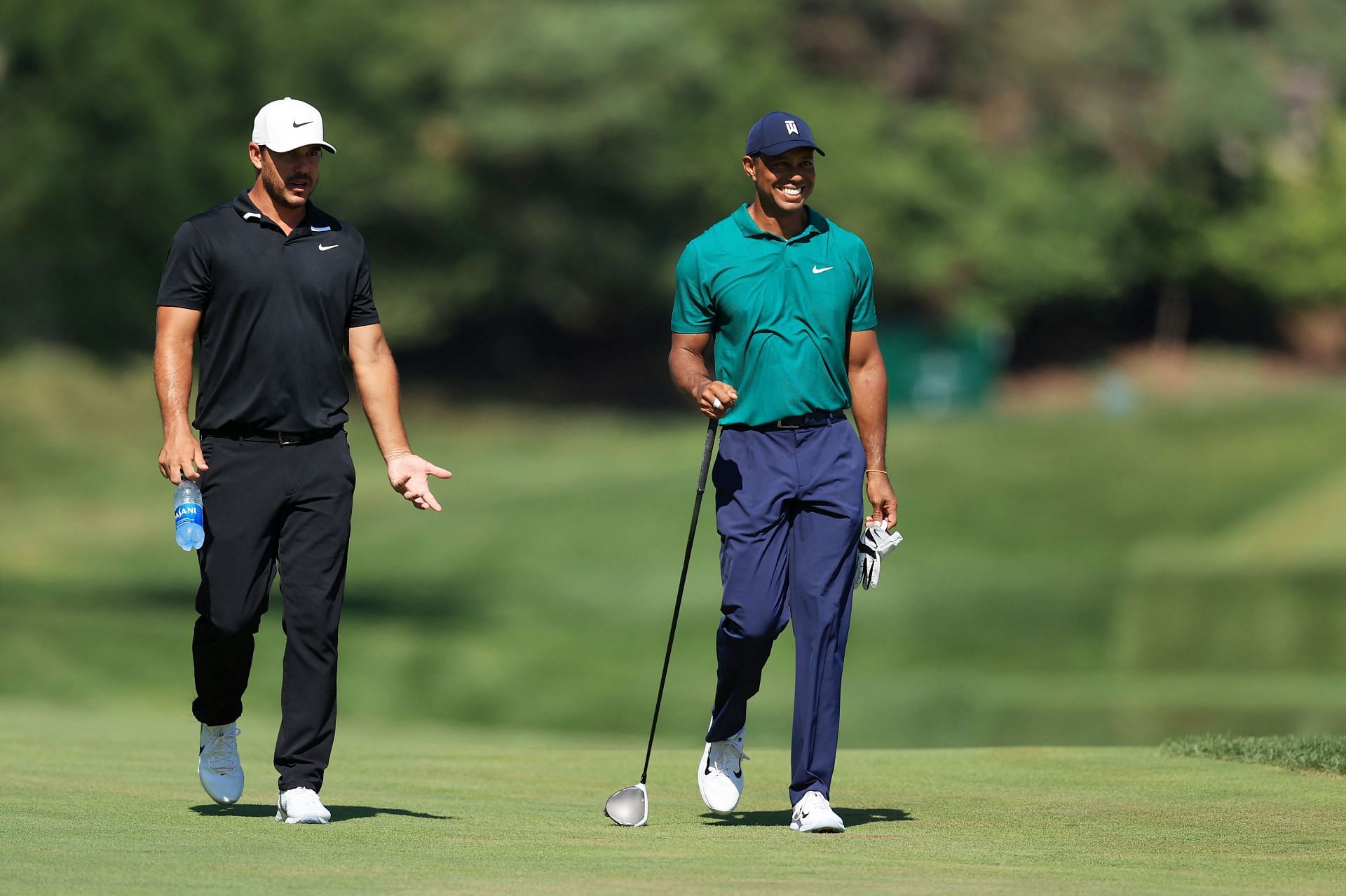 Brooks Koepka and Tiger Woods on the course