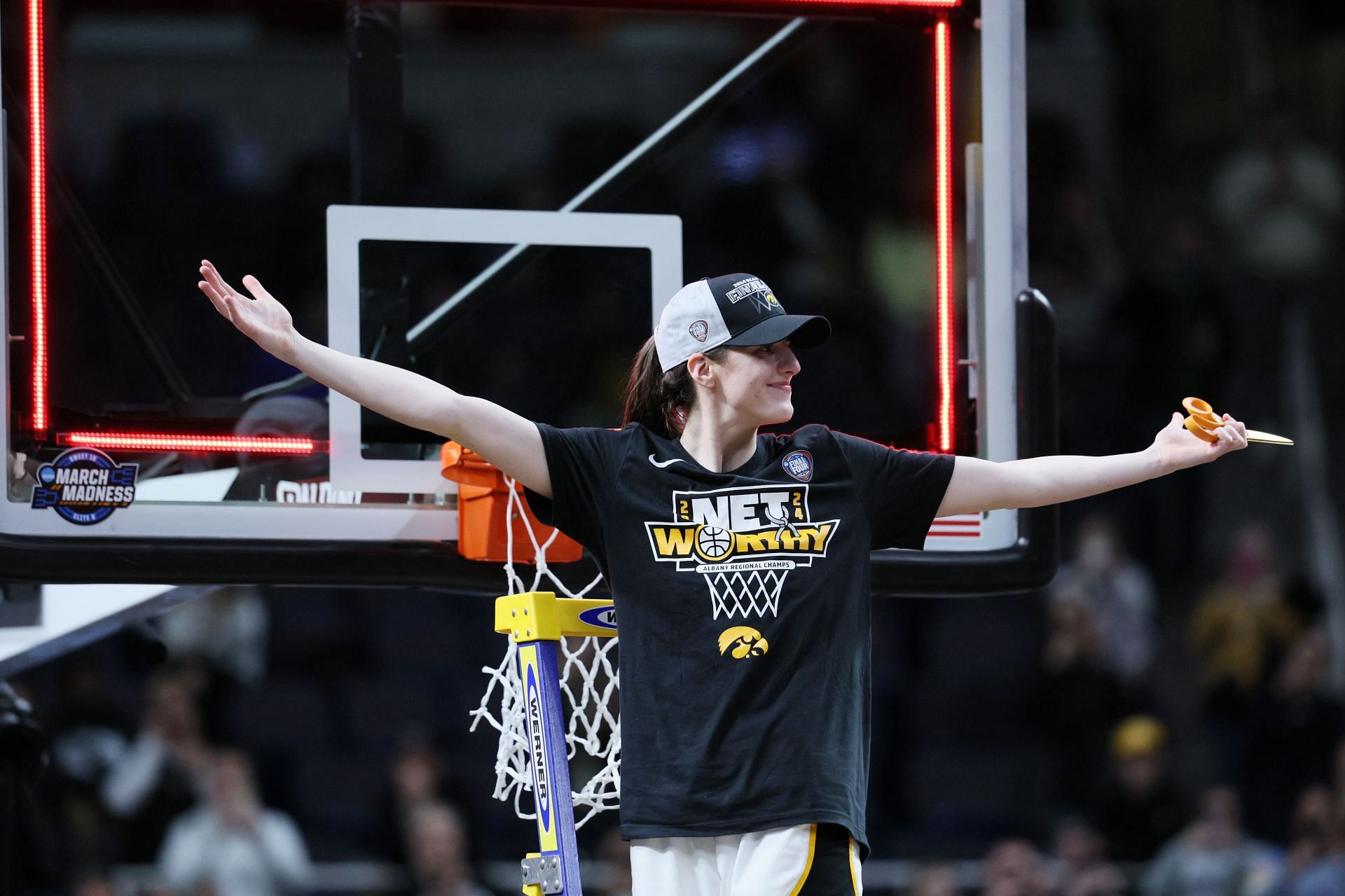 Caitlin Clark #22 of the Iowa Hawkeyes cuts down the net after beating the LSU Tigers 94-87 in the Elite 8.