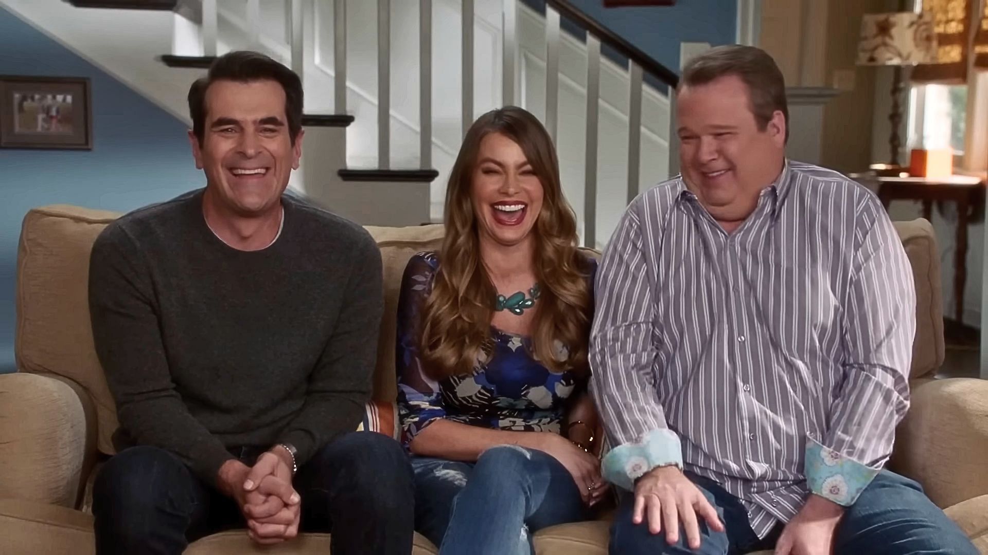 Phil (left), Gloria (middle), and Cam (right) in Modern Family (Image via YouTube/Peacock, 0:01)