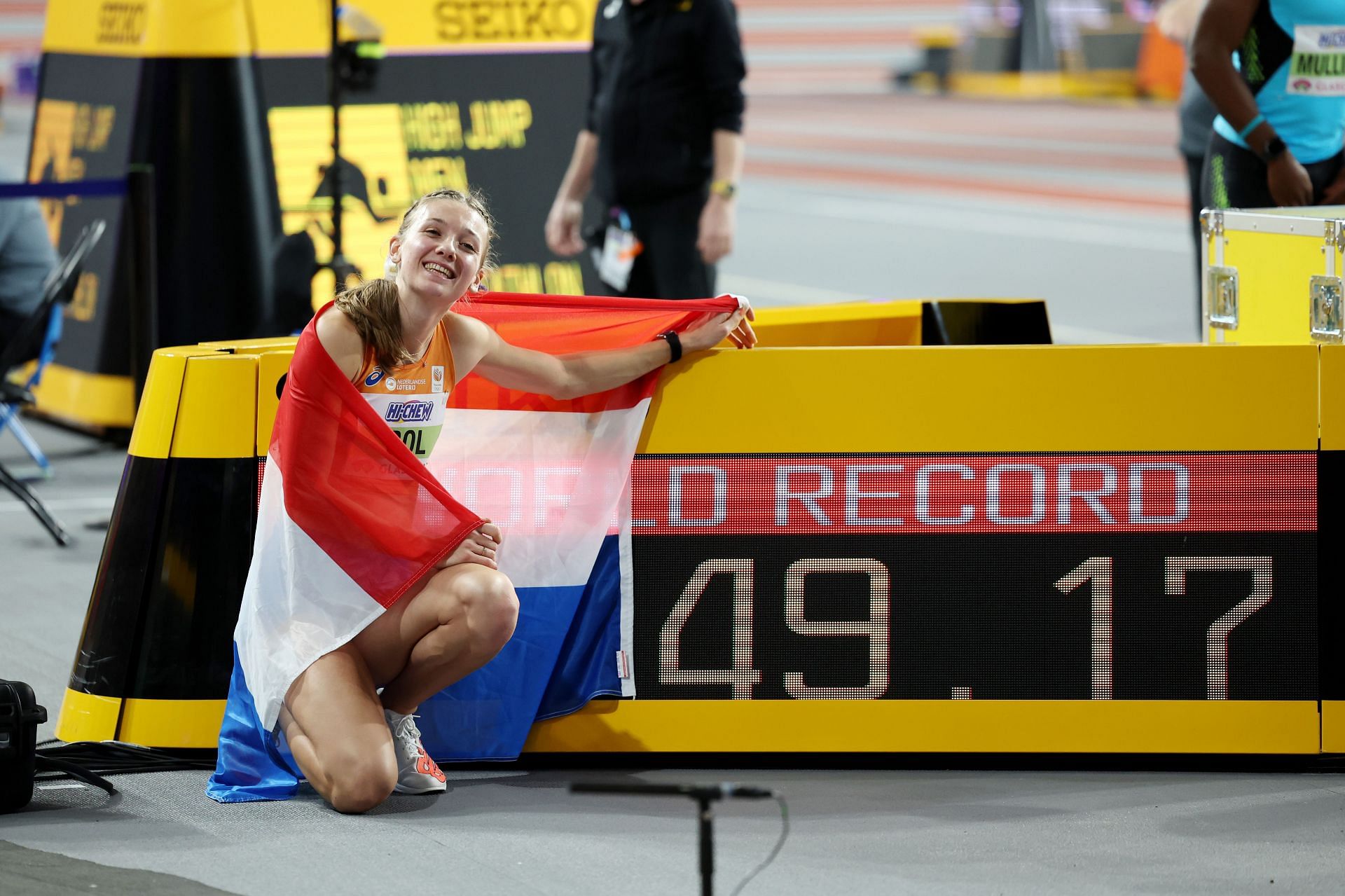 Femke Bol poses for a photo with the scoreboard after setting a new World Record in the 400 Metres at the 2024 World Athletics Indoor Championships in Glasgow, Scotland