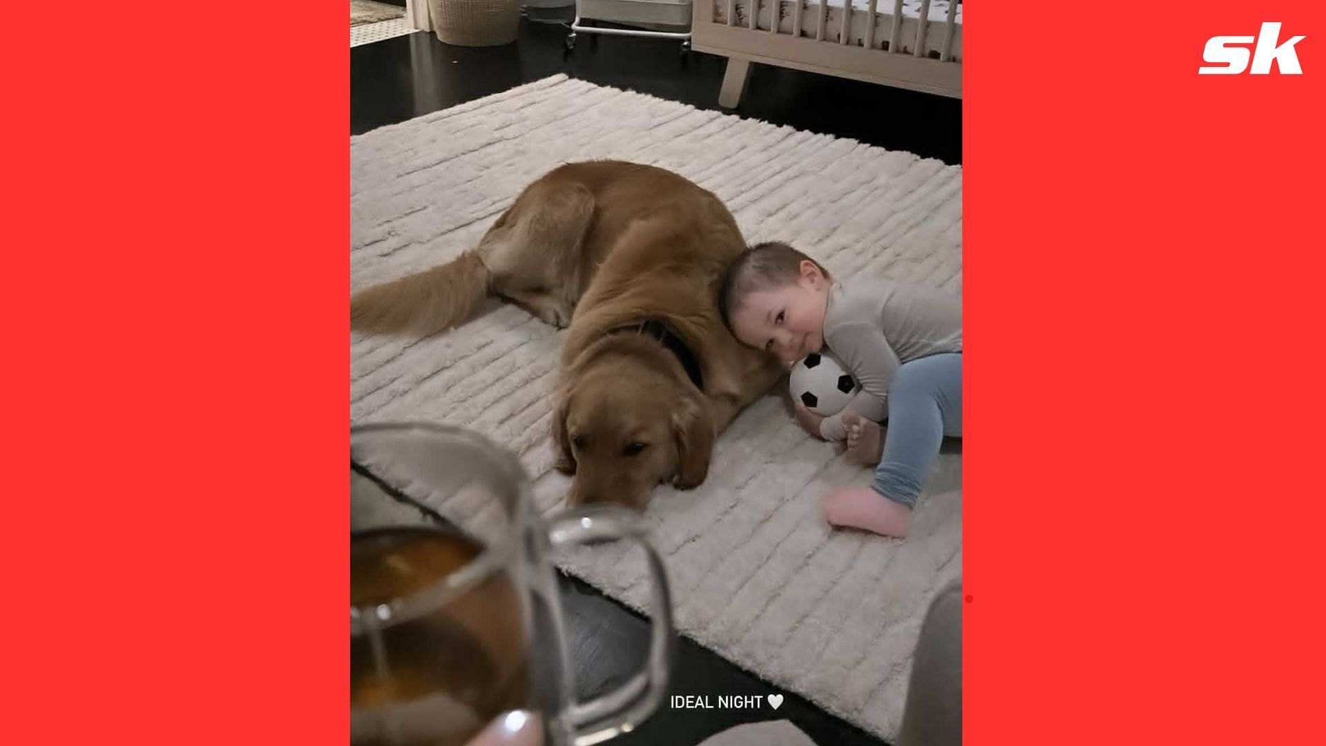 Knox Bregman snuggling with the Bregman family dog