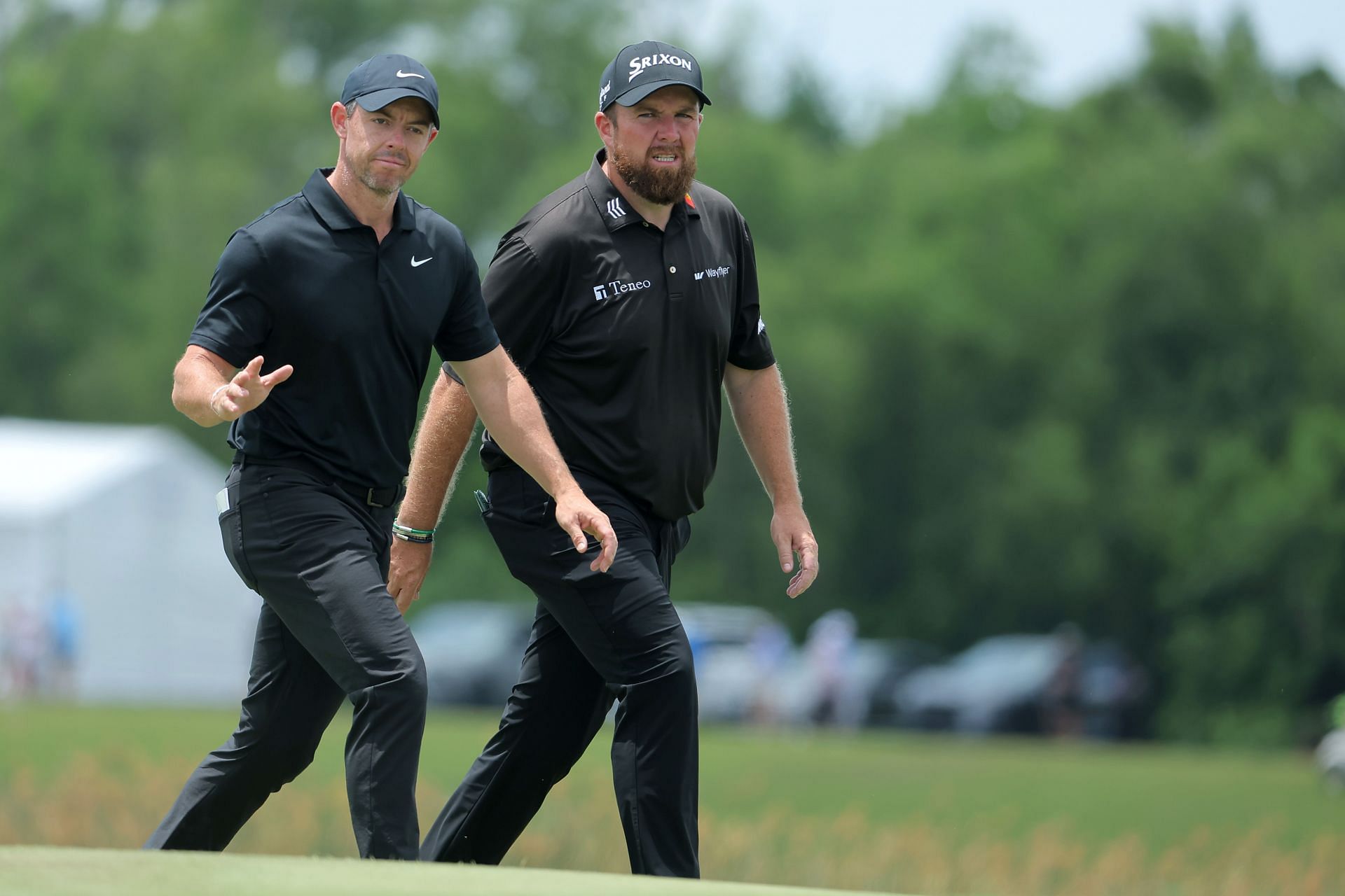 Rory McIlroy and Shane Lowry wave on the ninth green during the second round of the Zurich Classic of New Orleans at TPC Louisiana