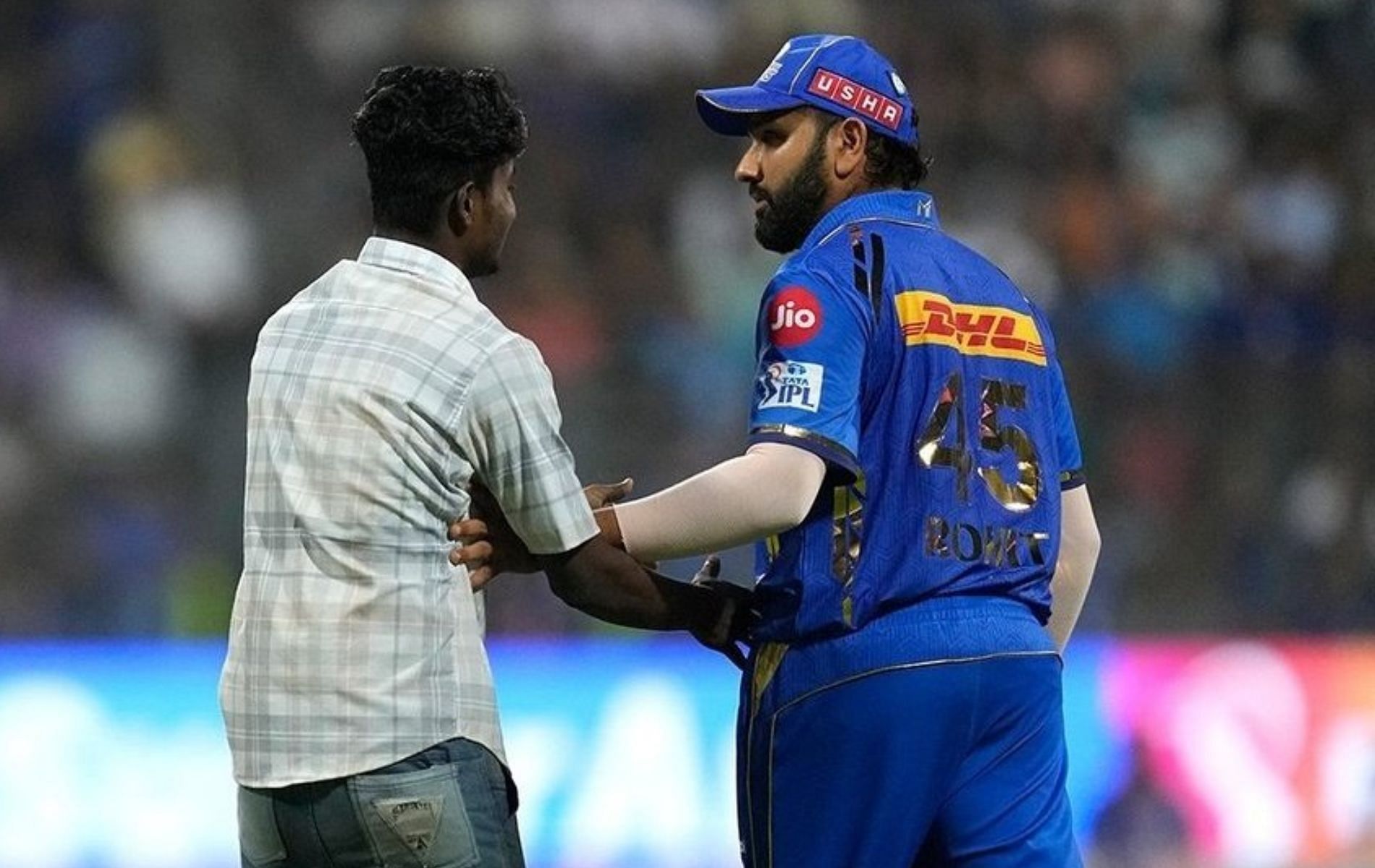 Rohit Sharma (R) was visibly surprised to see the fan on the field.
