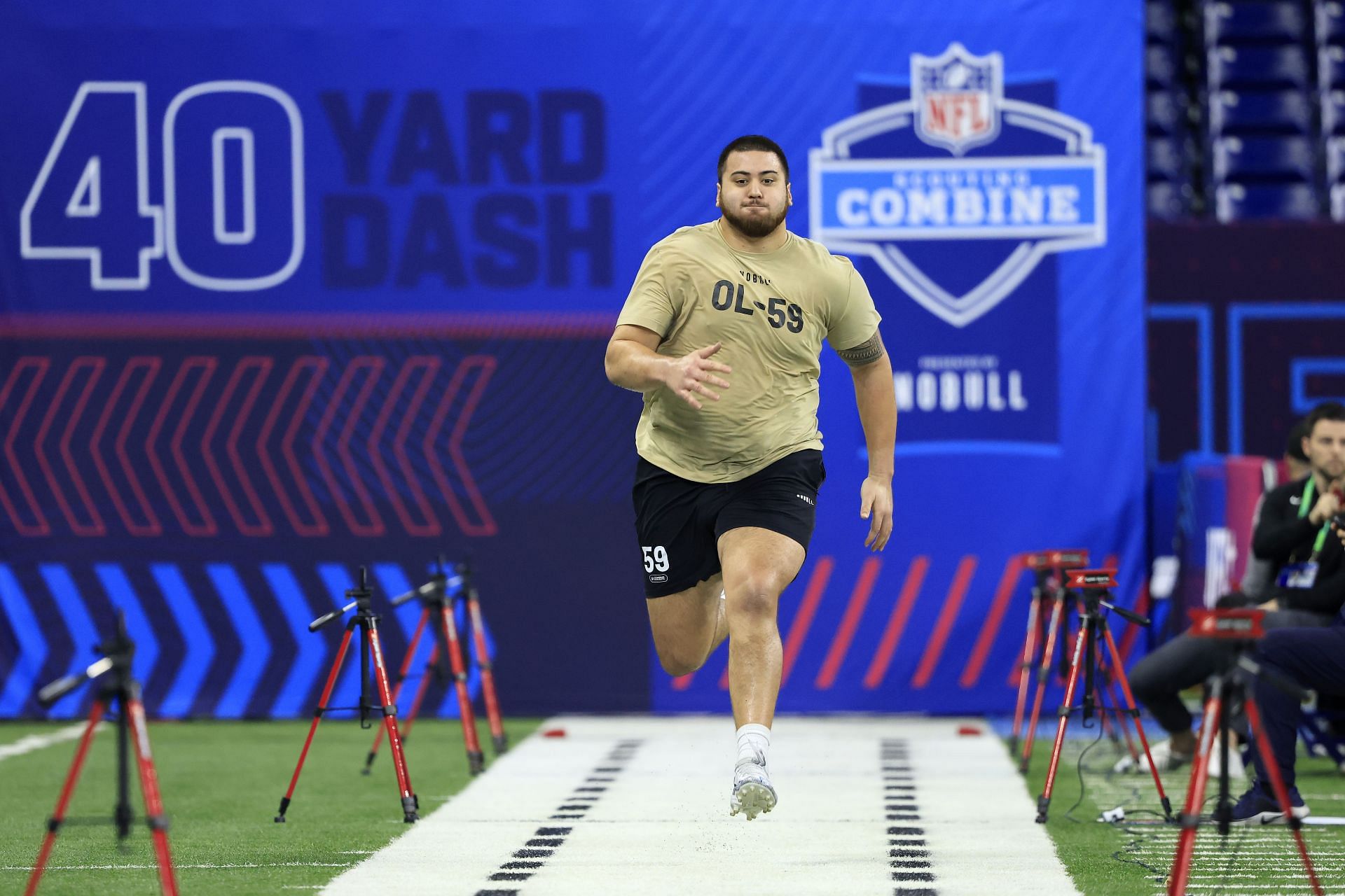 Dominick Puni #OL59 of Kansas participates in the 40-yard dash during the NFL Combine