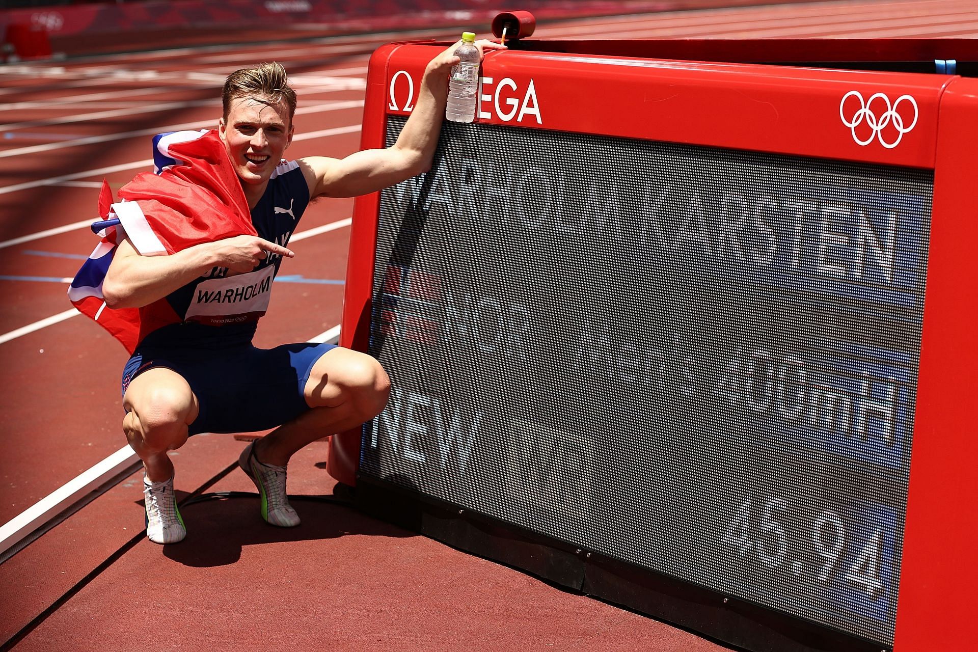 Karsten Warholm of Team Norway poses with a scoreboard showing his new world record time after winning the gold medal in the Men&#039;s 400m Hurdles Final at the 2020 Olympic Games in Tokyo, Japan.