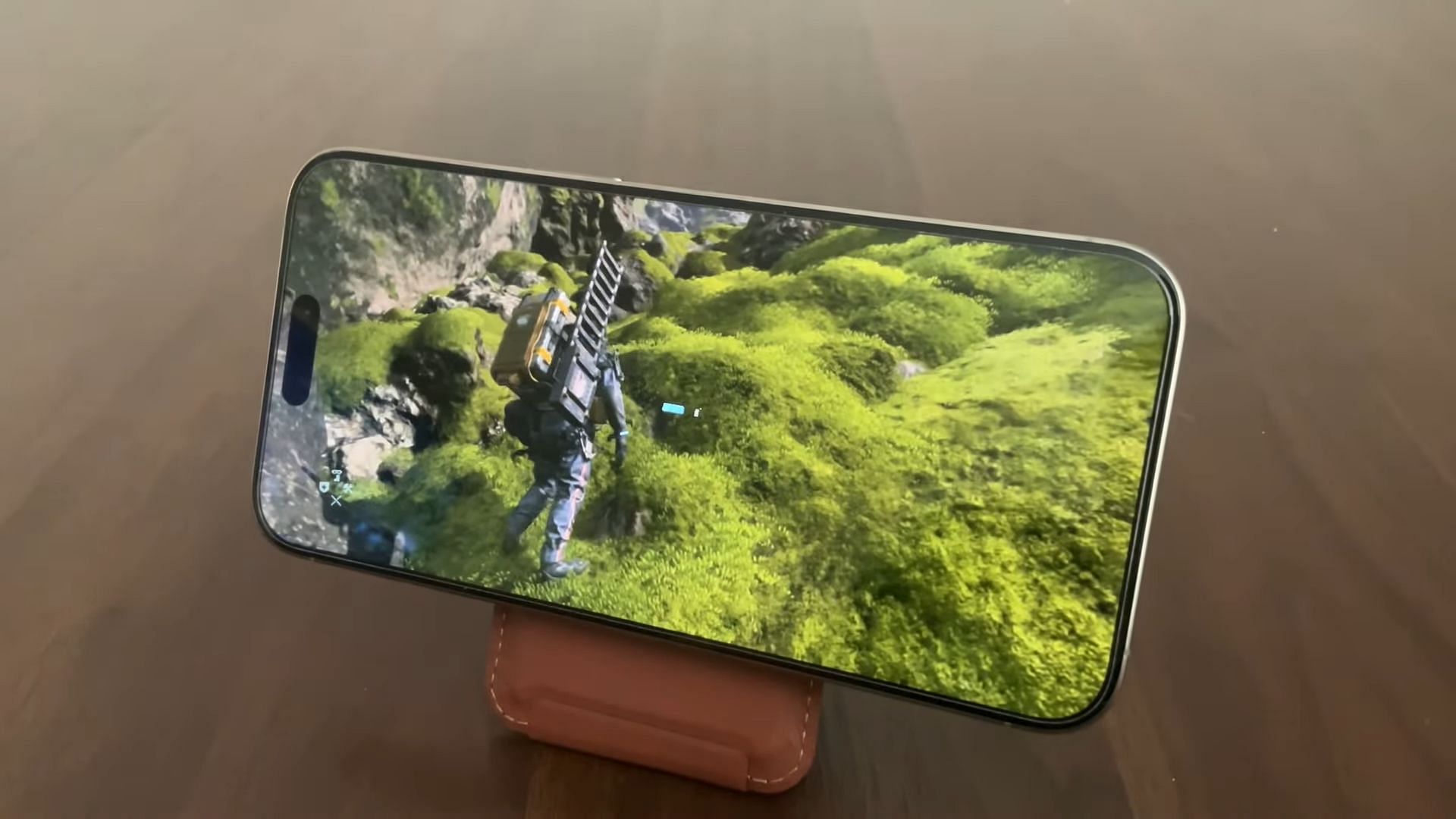 iPhone 15 Pro running Death Stranding (Image via Apple || 505 Games || The Tech Playoffs/YouTube)