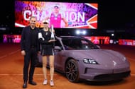 Porsche CEO Oliver Blume (L) and Elena Rybakina (R) posing afte the latter's Porsche Tennis Grand Prix Stuttgart 2024 triumph