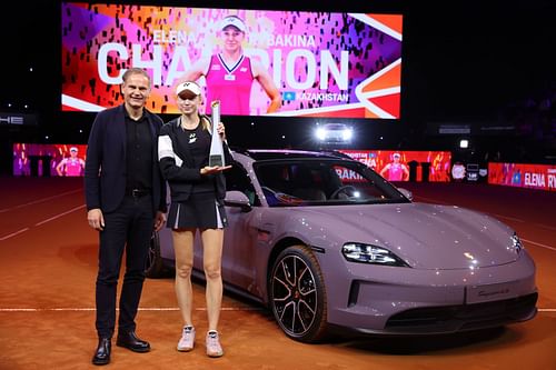 Porsche CEO Oliver Blume (L) and Elena Rybakina (R) posing afte the latter's Porsche Tennis Grand Prix Stuttgart 2024 triumph