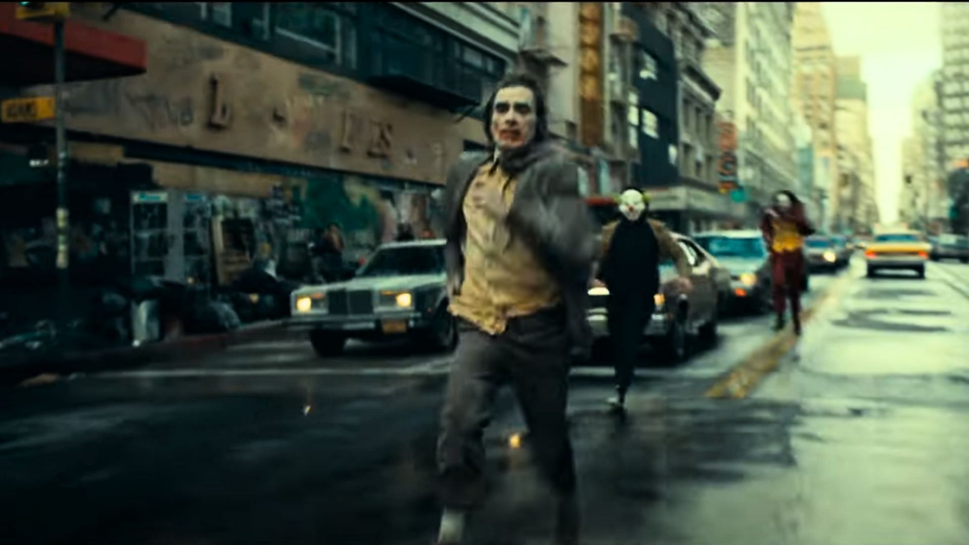 Two jokers are shown chasing Arthur Fleck (Image via Warner Bros.)