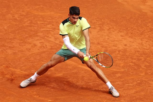 Carlos Alcaraz stretches to hit a backhand at the 2024 Madrid Open