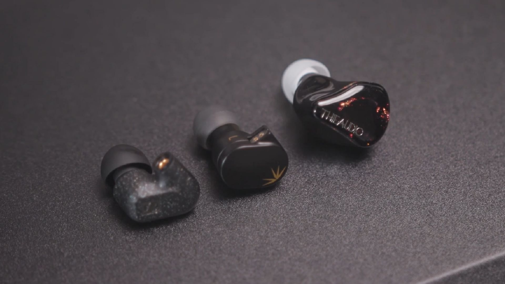 Picture of three IEM earbuds on a table