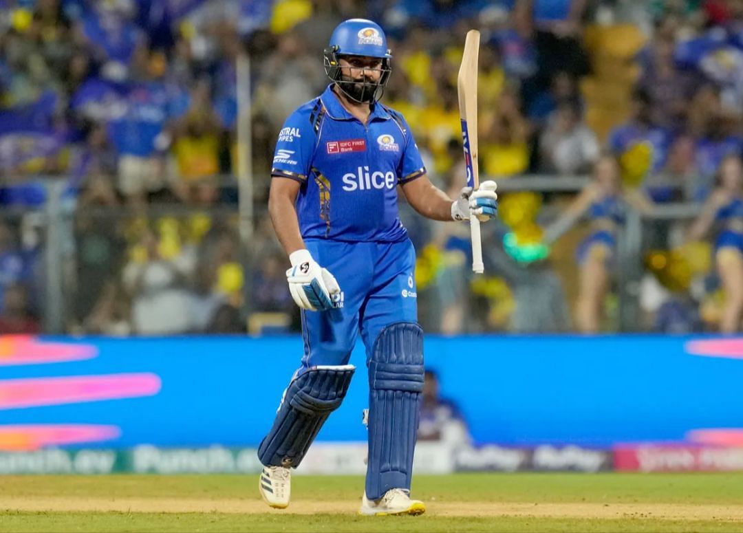 Rohit Sharma putting his bat up after his fifty