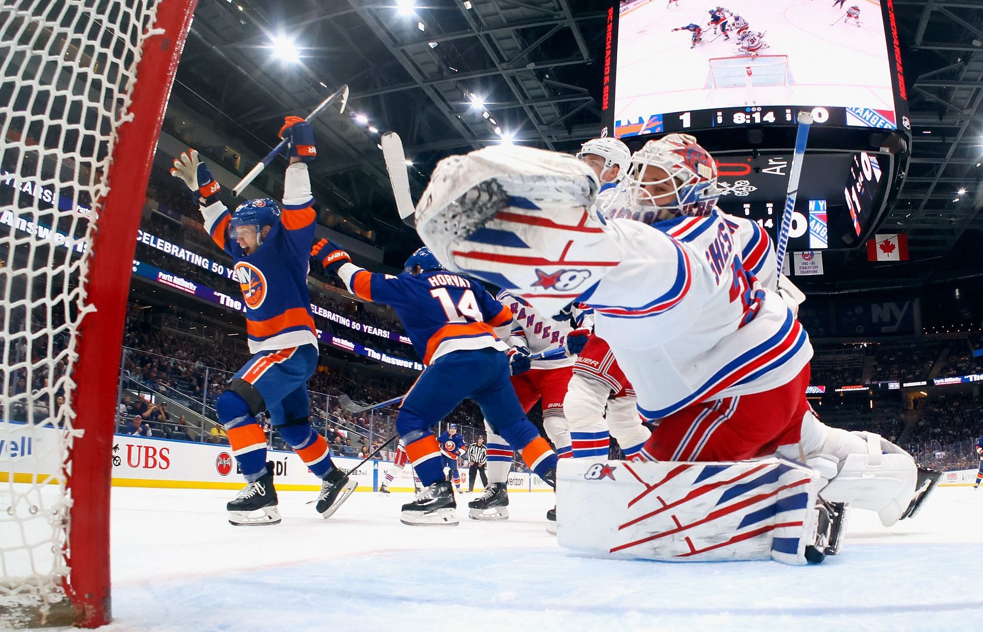 Islanders players celebrate after scoring against New York Rangers&#039; Igor Shesterkin