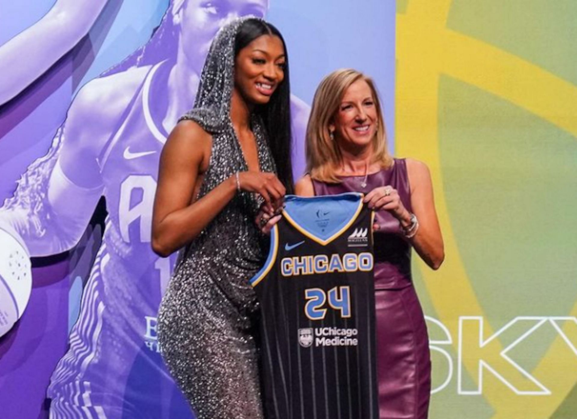 Angel Reese holding her Chicago Sky jersey with WNBA commissioner Cathy Engelbert.