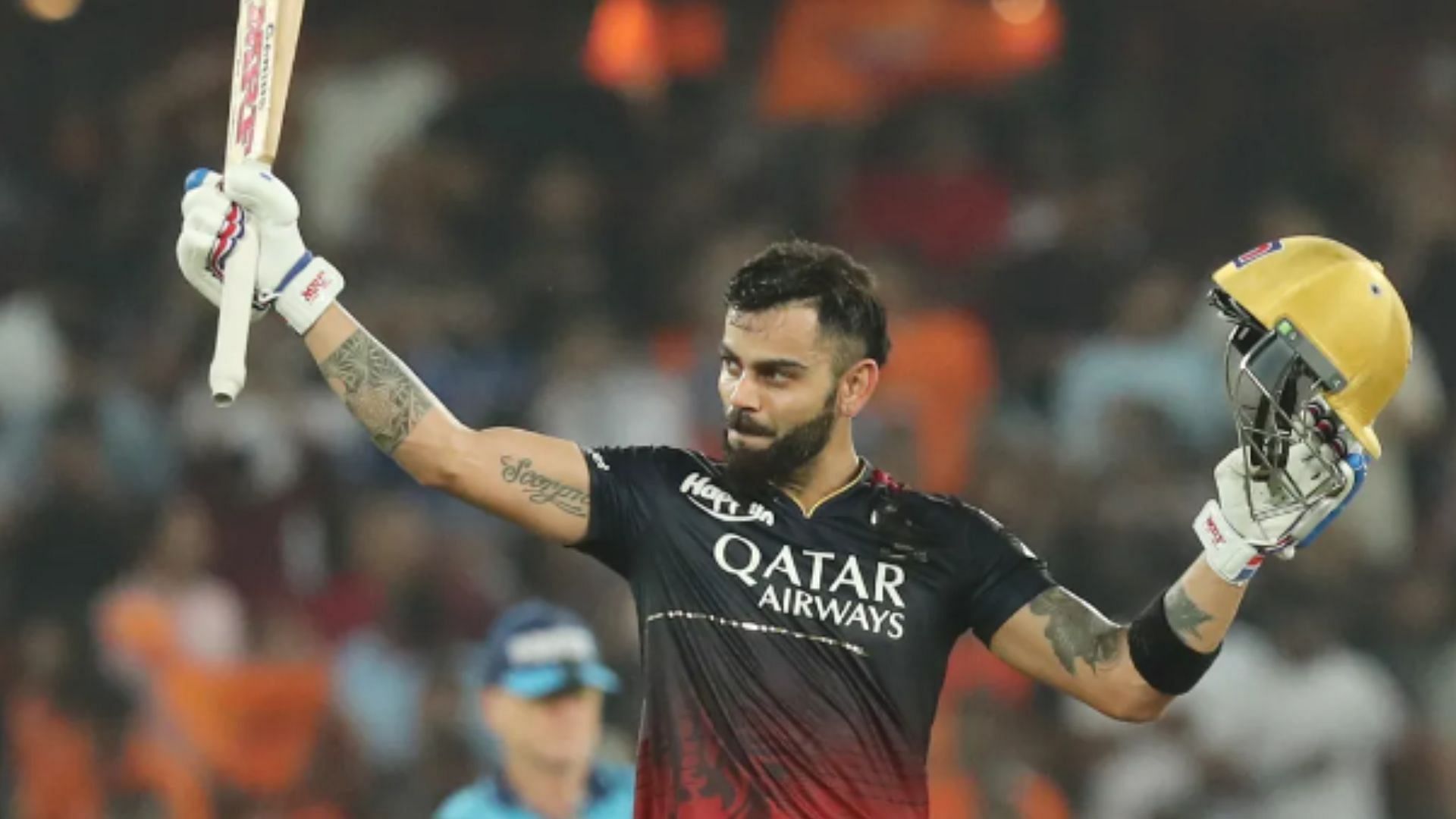 Virat raises his bat after scoring a century against SRH in 2023.