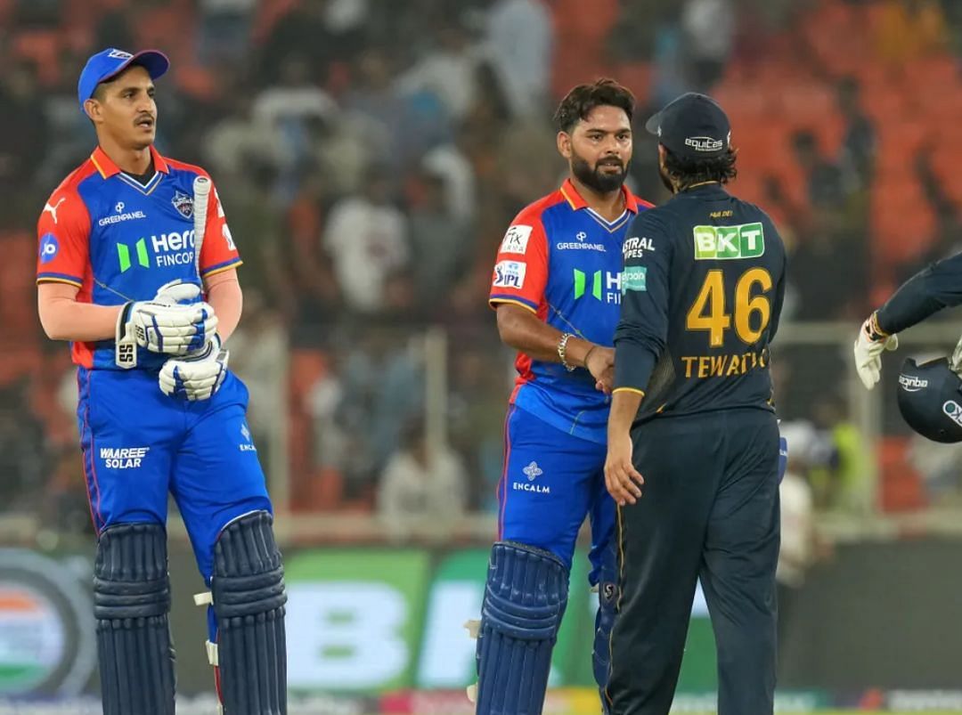 Rishabh Pant and Sumit Kumar shaking hands with GT players after the win