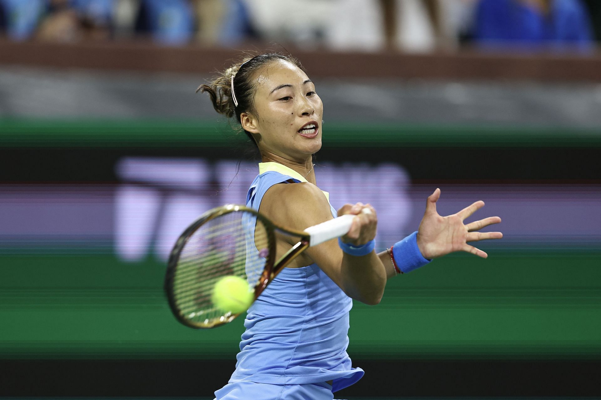 Zheng Qinwen hits a forehand at BNP Paribas Open 2024