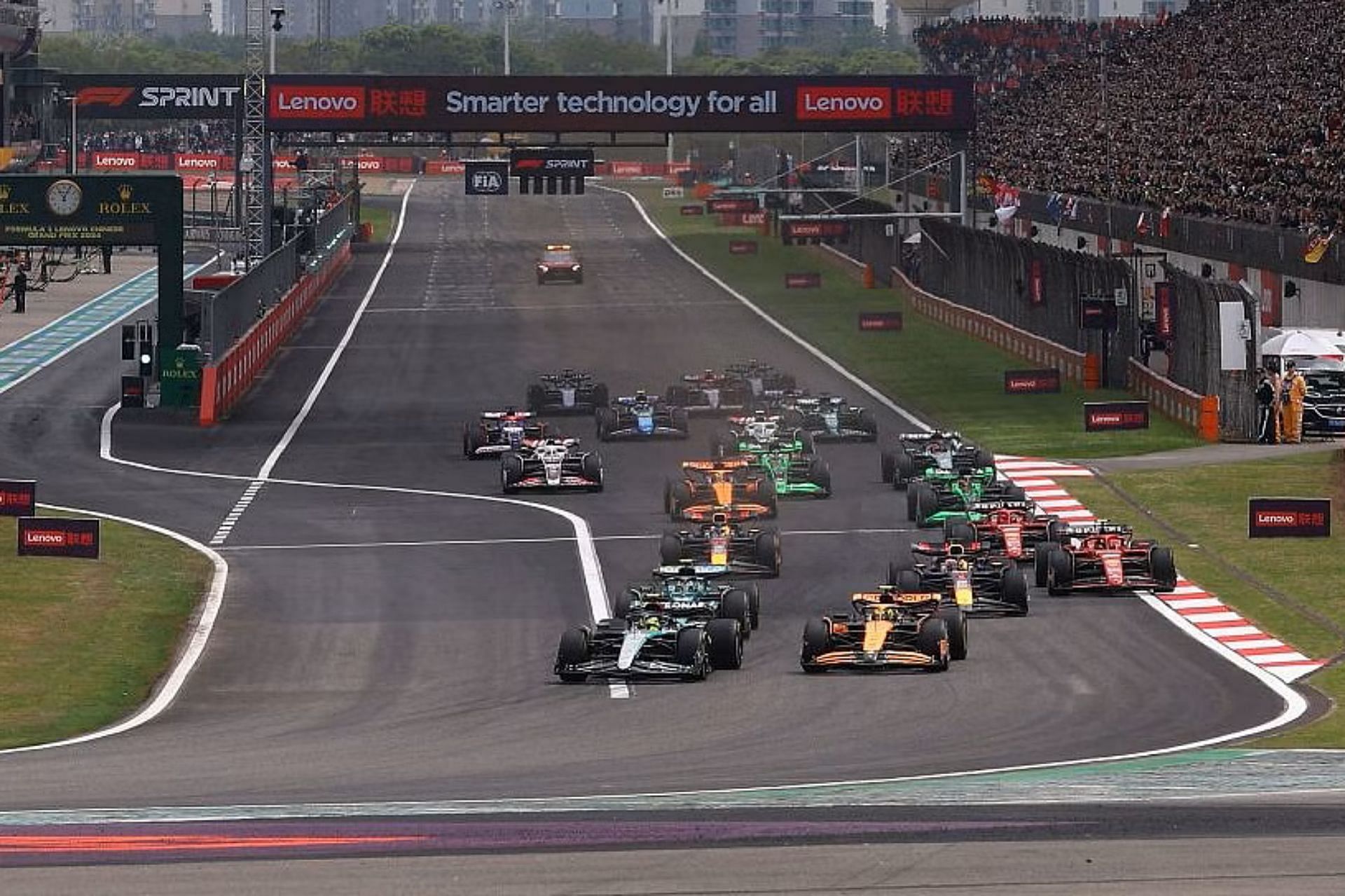 Lewis Hamilton (44) and Lando Norris (4) lead the field into turn one at the start of the Sprint ahead of the 2024 F1 Chinese Grand Prix. (Photo by Lars Baron/Getty Images)