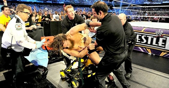 Bryan Danielson gets checked out by medical team after he scarily landed on his neck